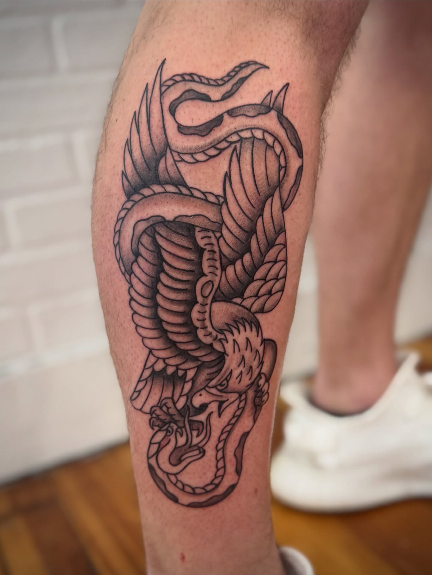 Rope snake black and grey tattoo on the thigh by Lindsay Shriver