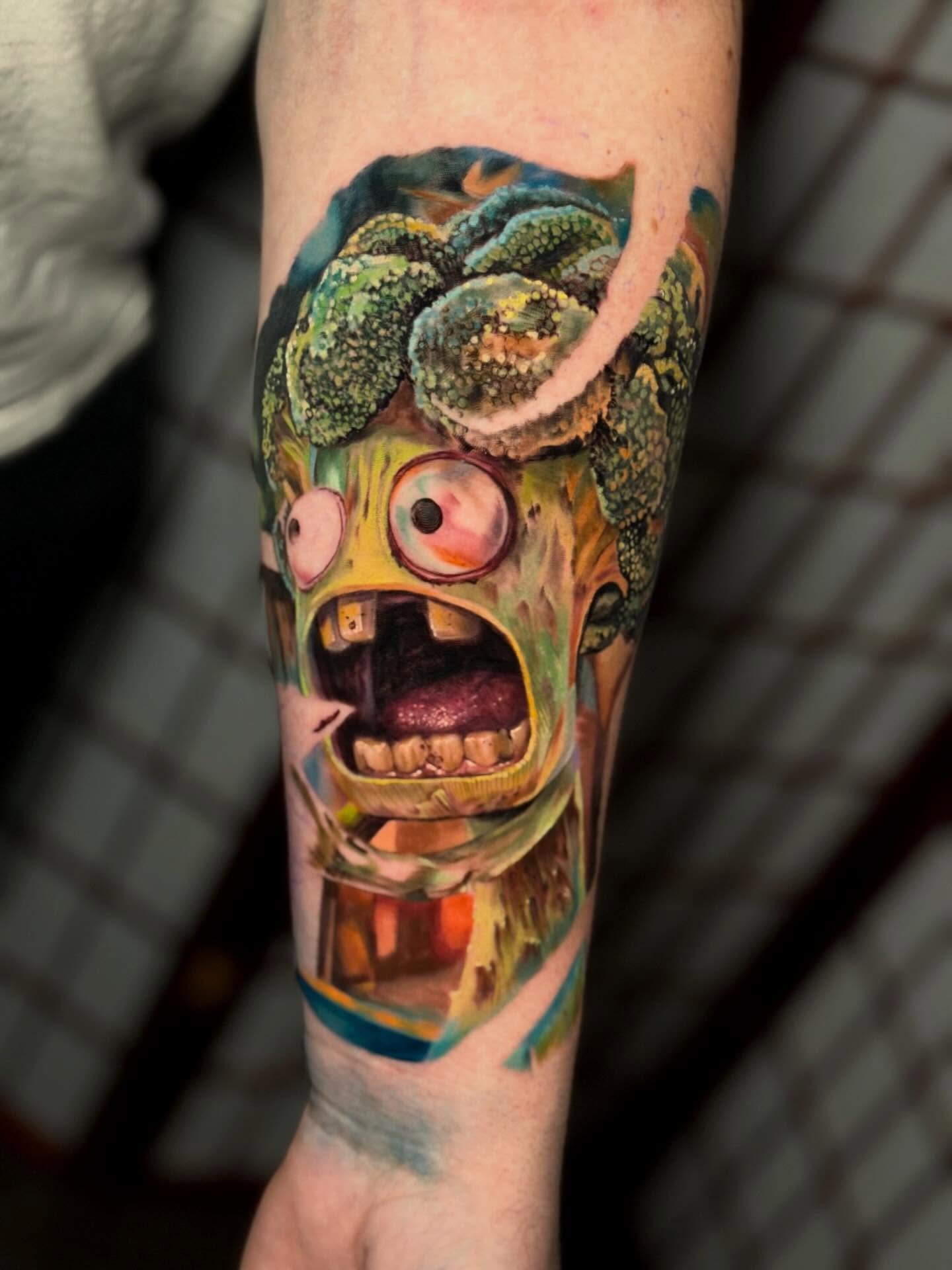 Zombie head realism tattoo on the forearm by Johnny Scillieri