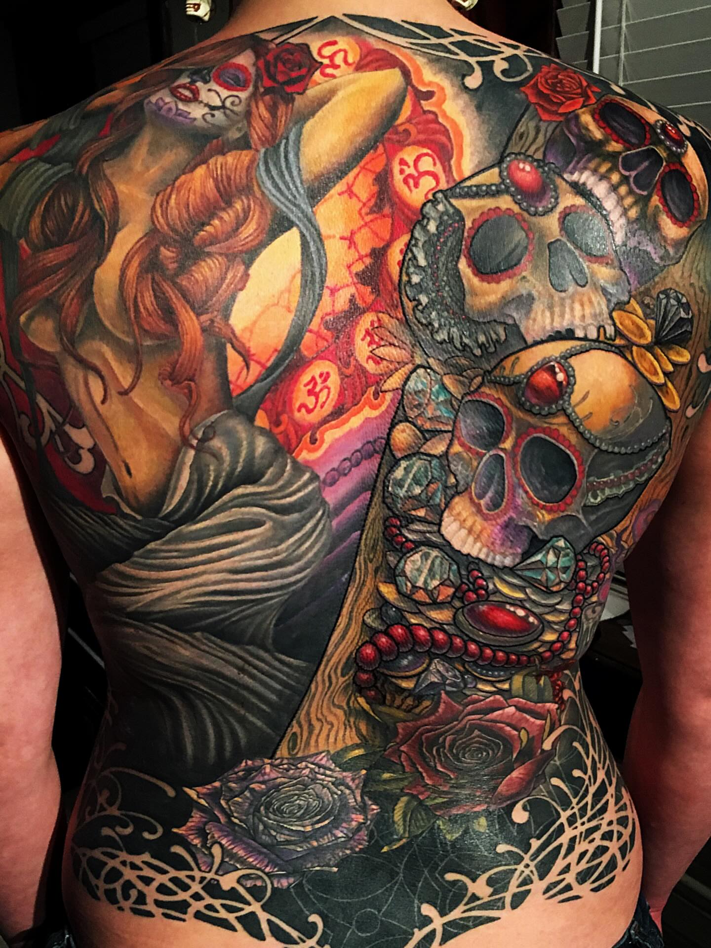 Sugar skulls and roses realism tattoo on the back by Patrick Delvar