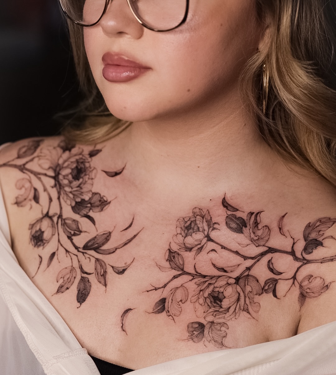 Floral black and grey tattoo on the chest by Maria