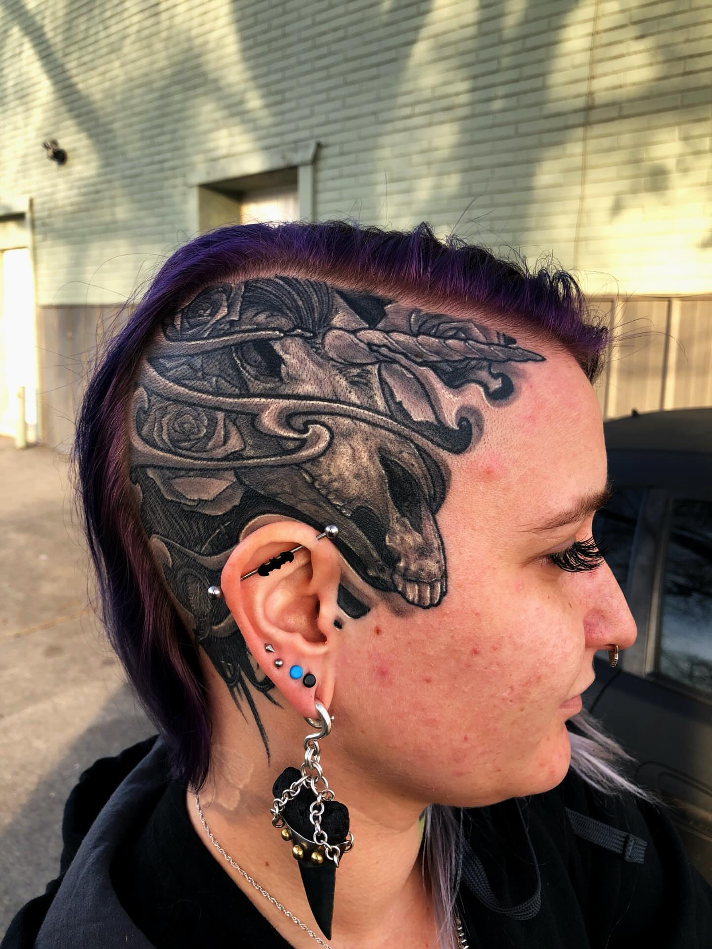 Skull and roses realism tattoo on the head by Patrick Delvar