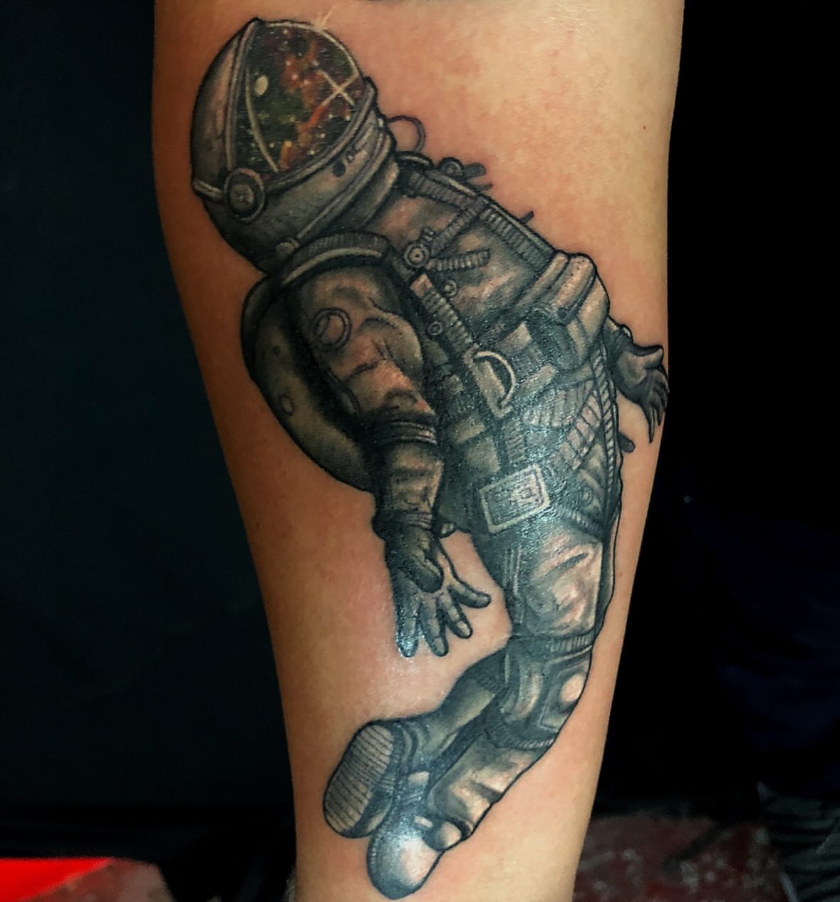 Astronaut realism tattoo on the forearm by Patrick Delvar