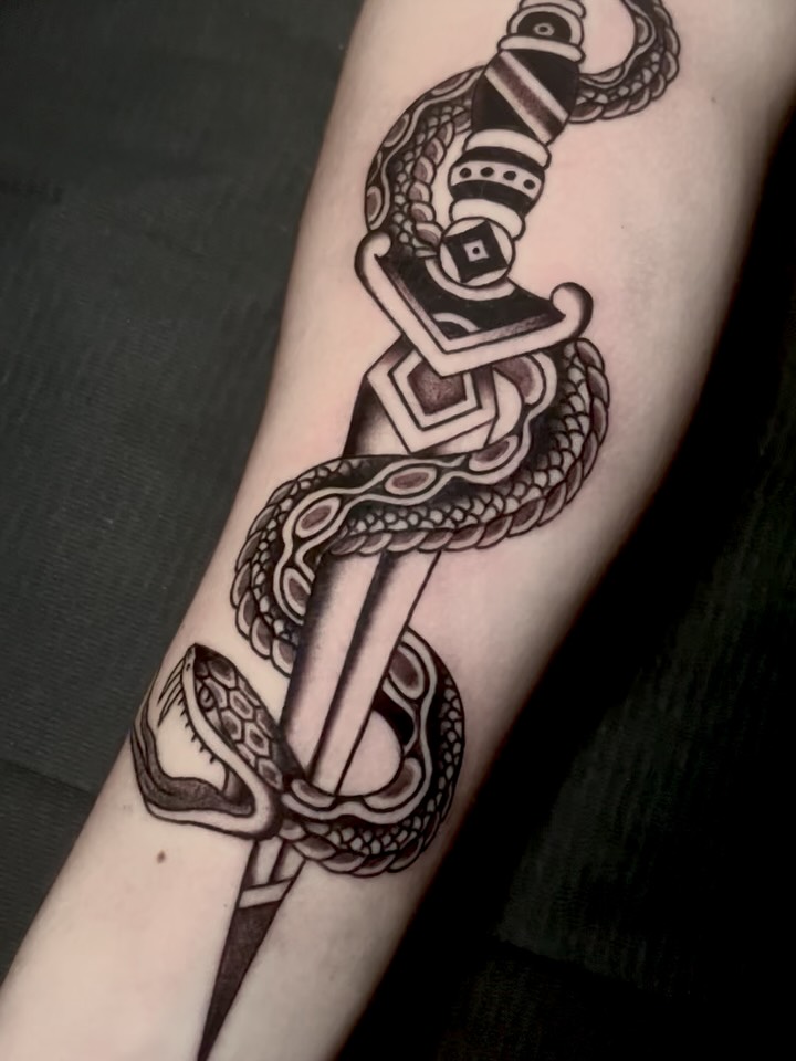 Snake and dagger black and grey tattoo on the forearm by JohnJohn