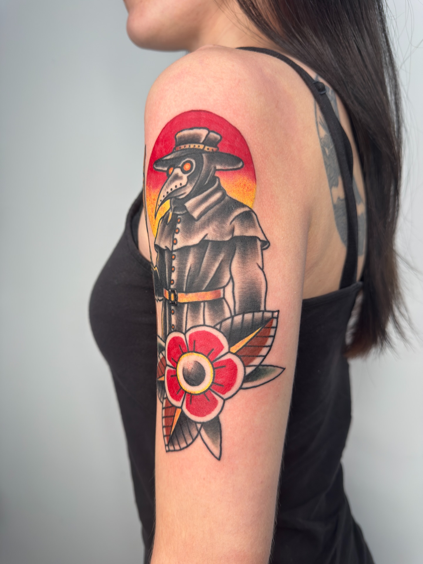 Plague doctor with flower American traditional tattoo on the shoulder by Joshua Carter