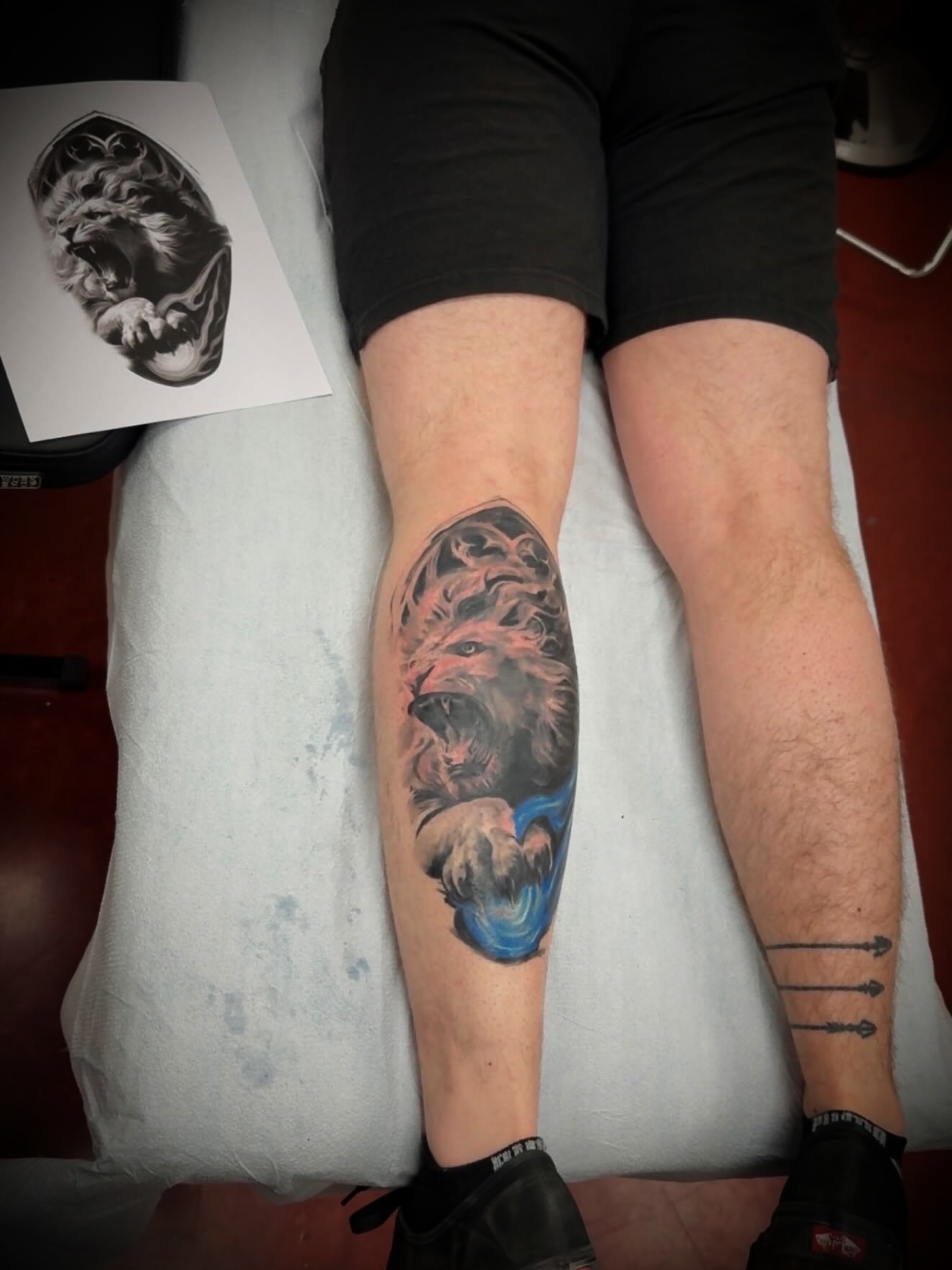 Roaring lion realism tattoo on the forearm by Julian Olson