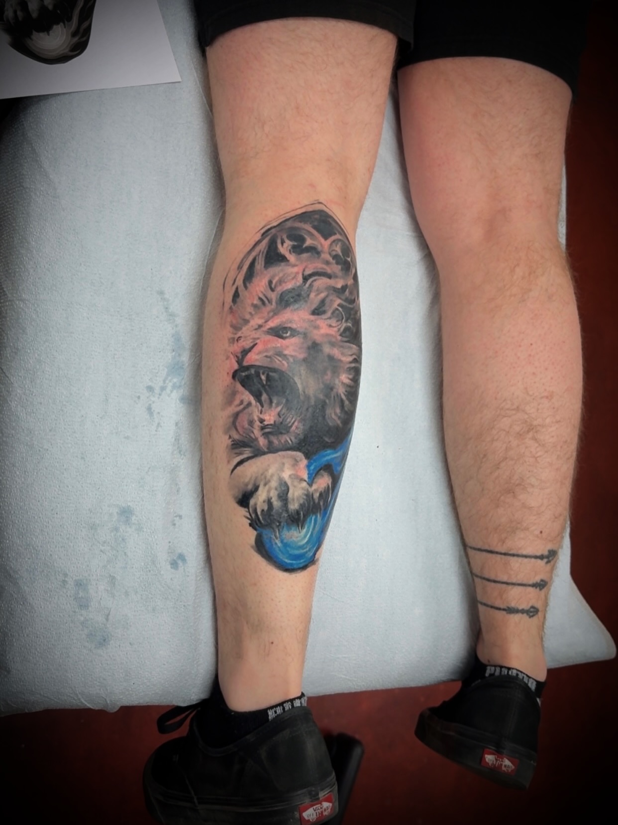 Lion realism tattoo on the calf by Julian Olson