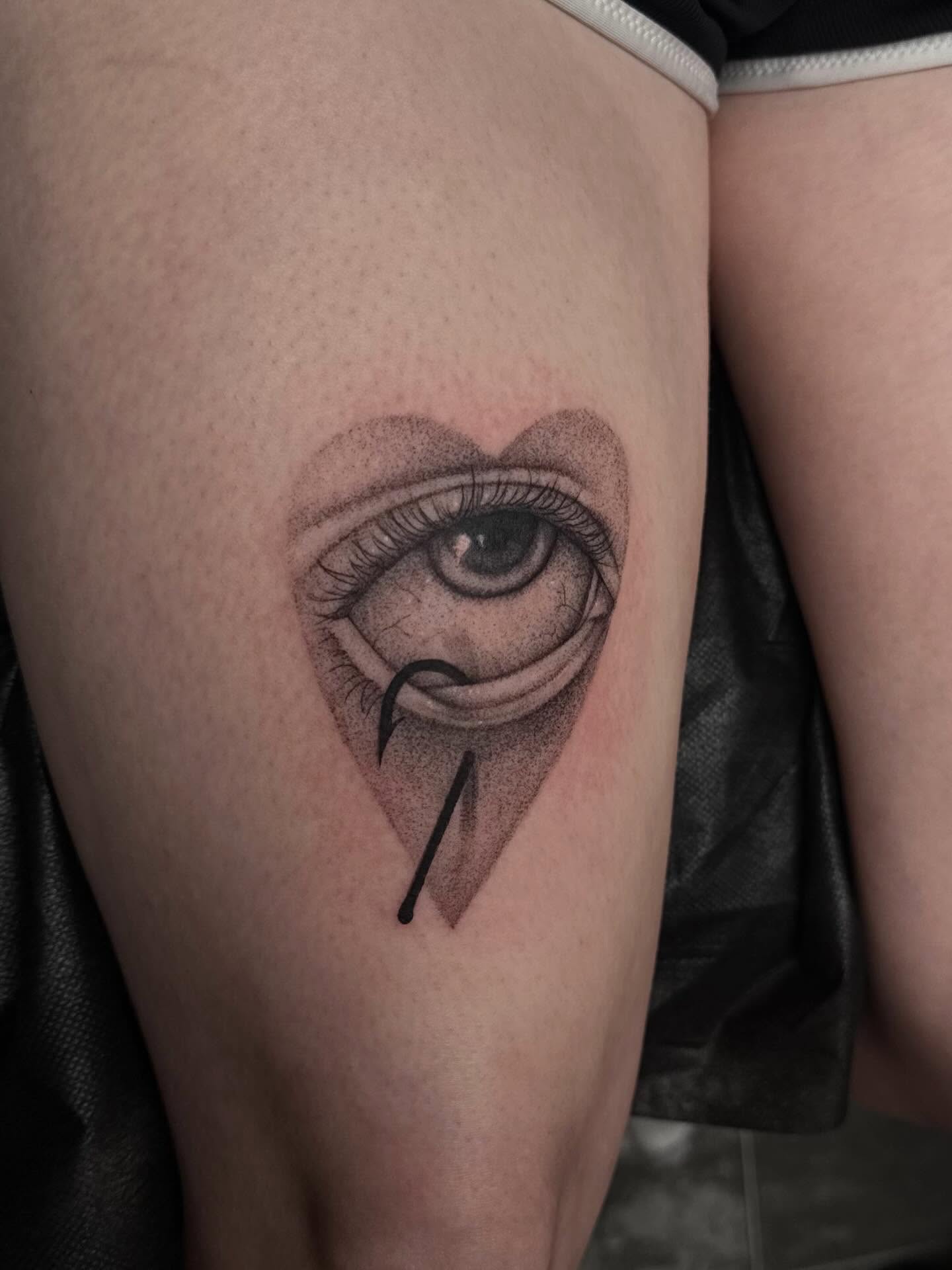 Eye with hook dotwork tattoo on the thigh by Madison Jasso