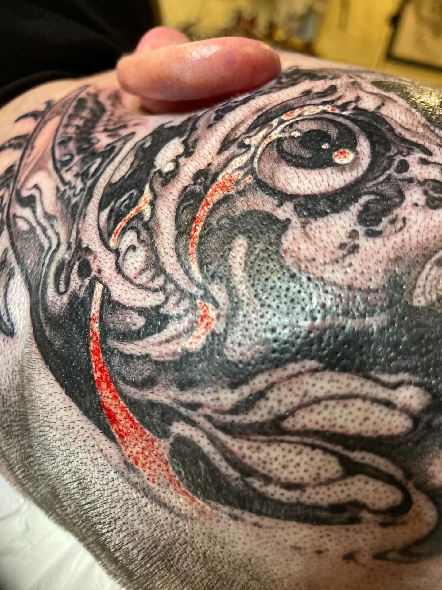 Eye dotwork tattoo on the torso by Billy Haines