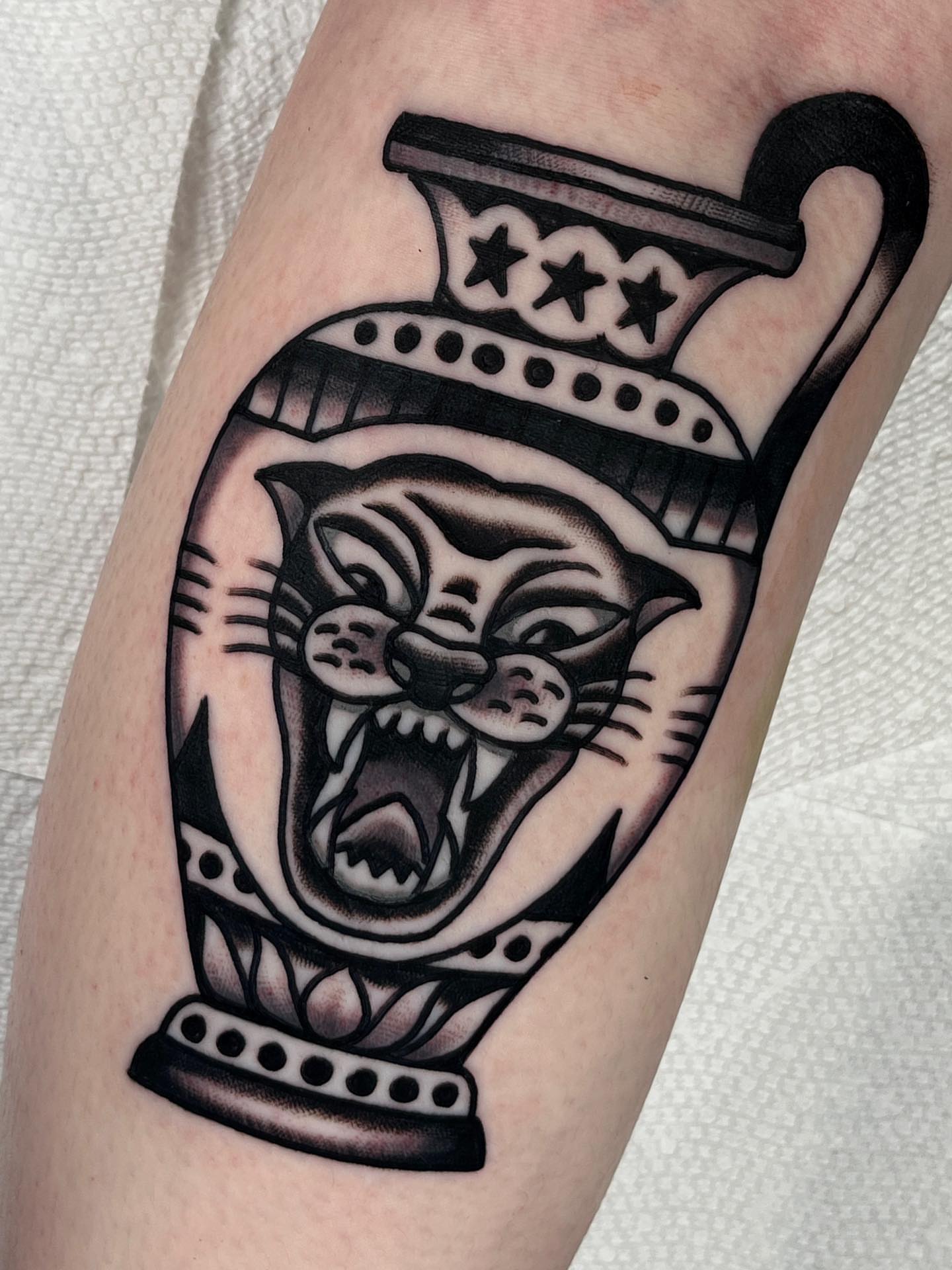 Angry cat American traditional tattoo on the forearm by Charlie Ostrom, Durham, North Carolina