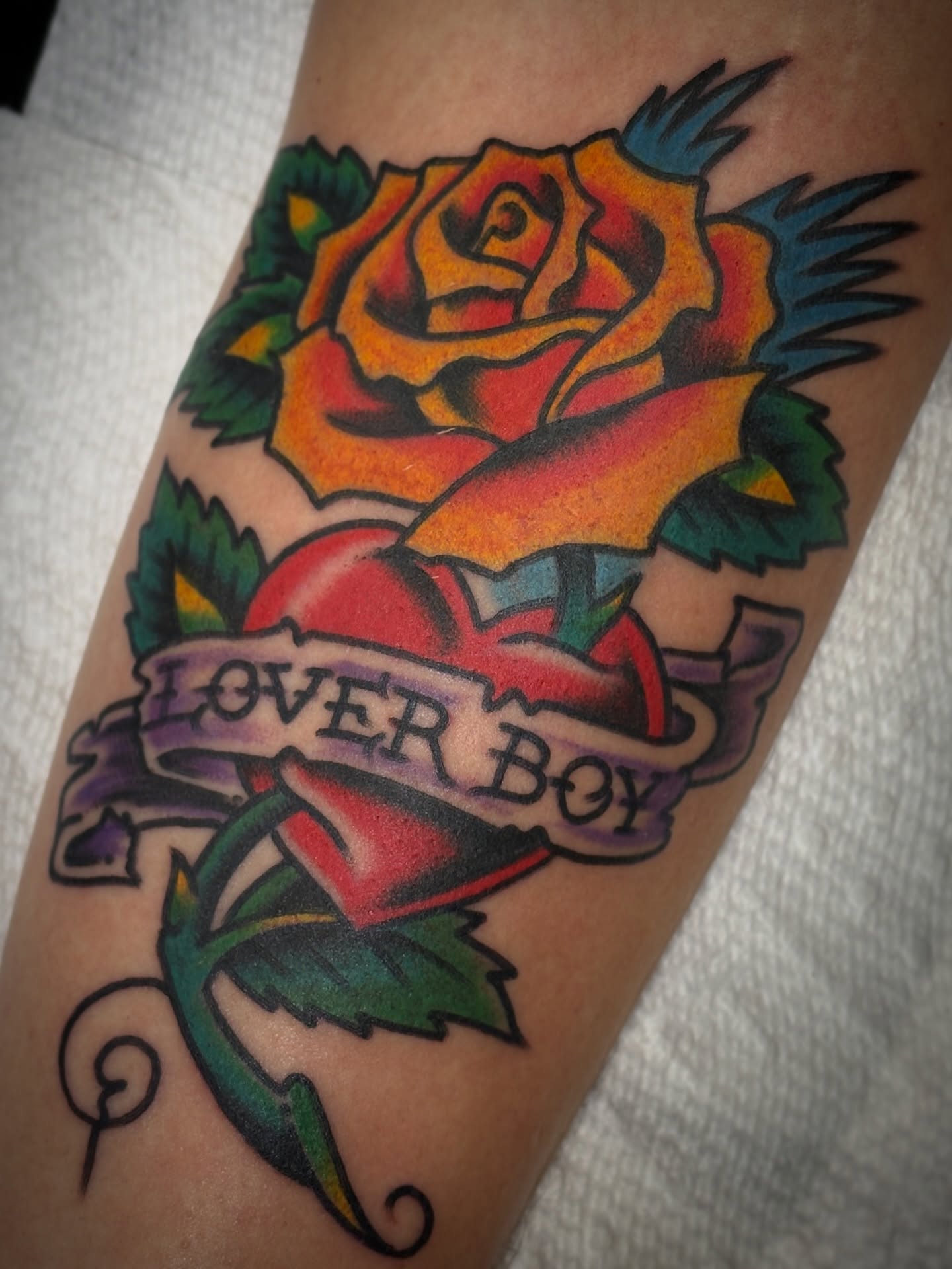 Rose American traditional tattoo on the forearm by Carlos Gonzalez Tattoo, Dallas, Texas