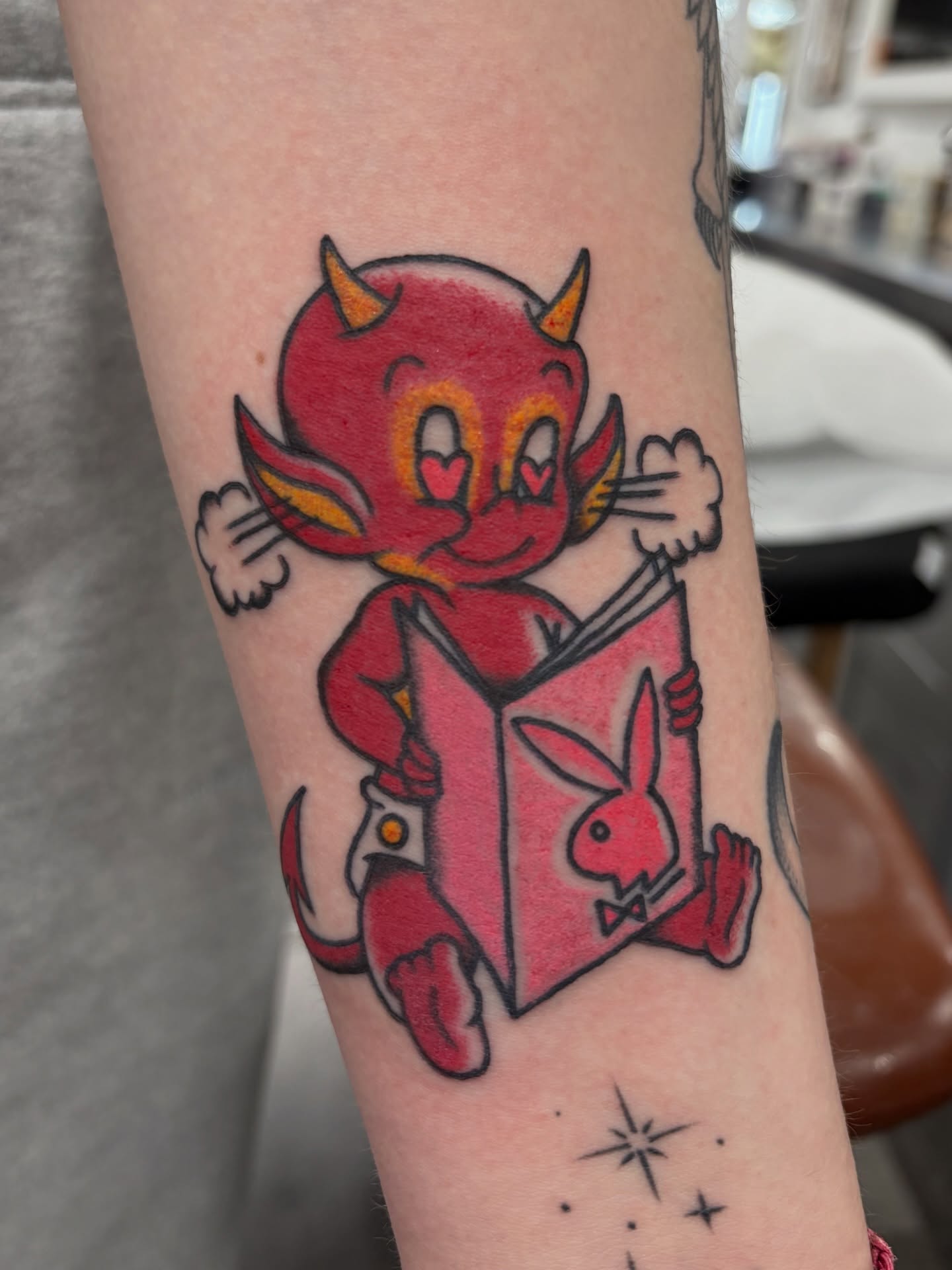 Chibi devil reading book American traditional tattoo on the forearm by Aysia Mankin-Wong, San Francisco, California