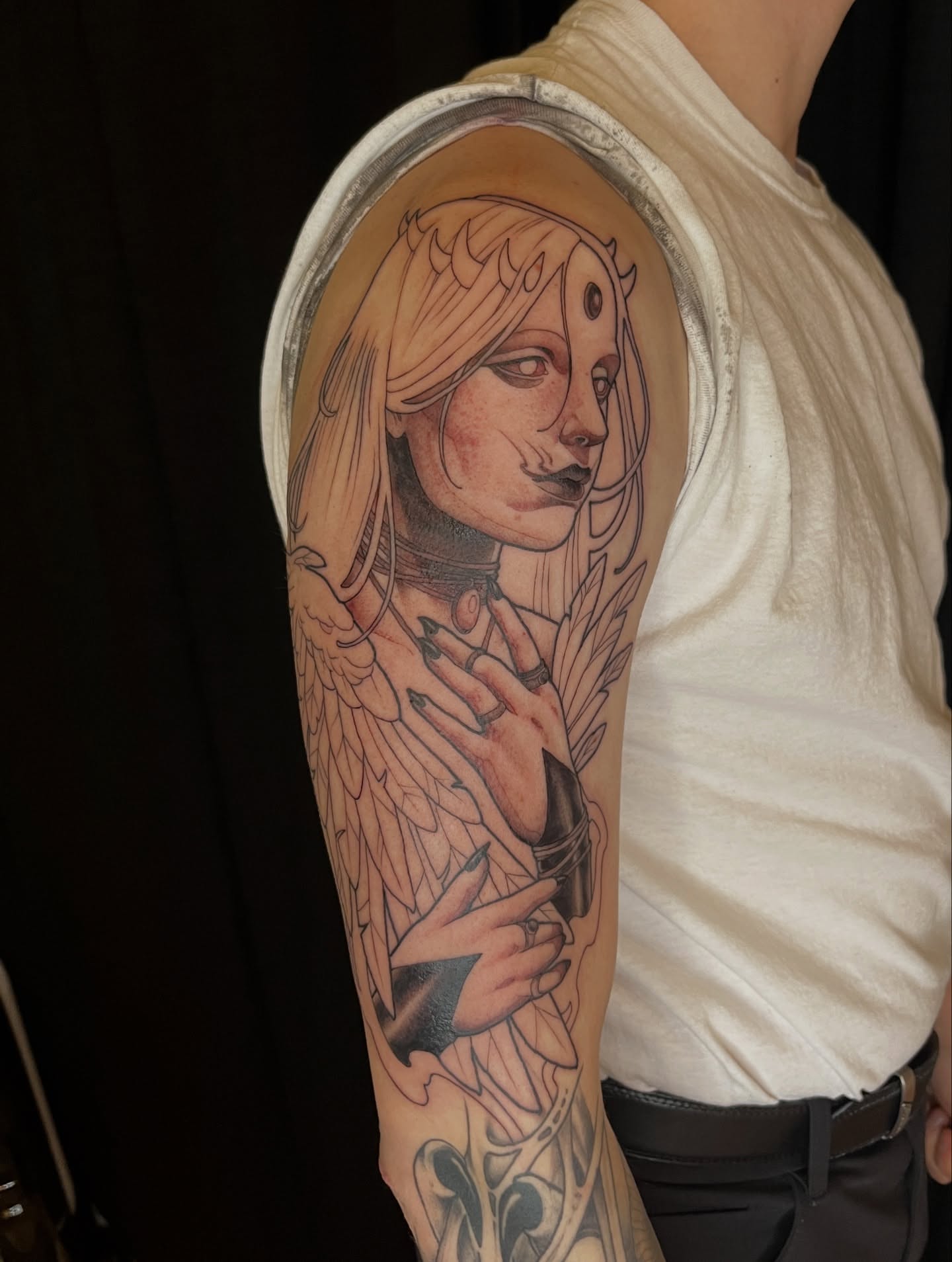 Angelic figure realism tattoo on the upper arm by BELLIE ✧ Tattoo Artist