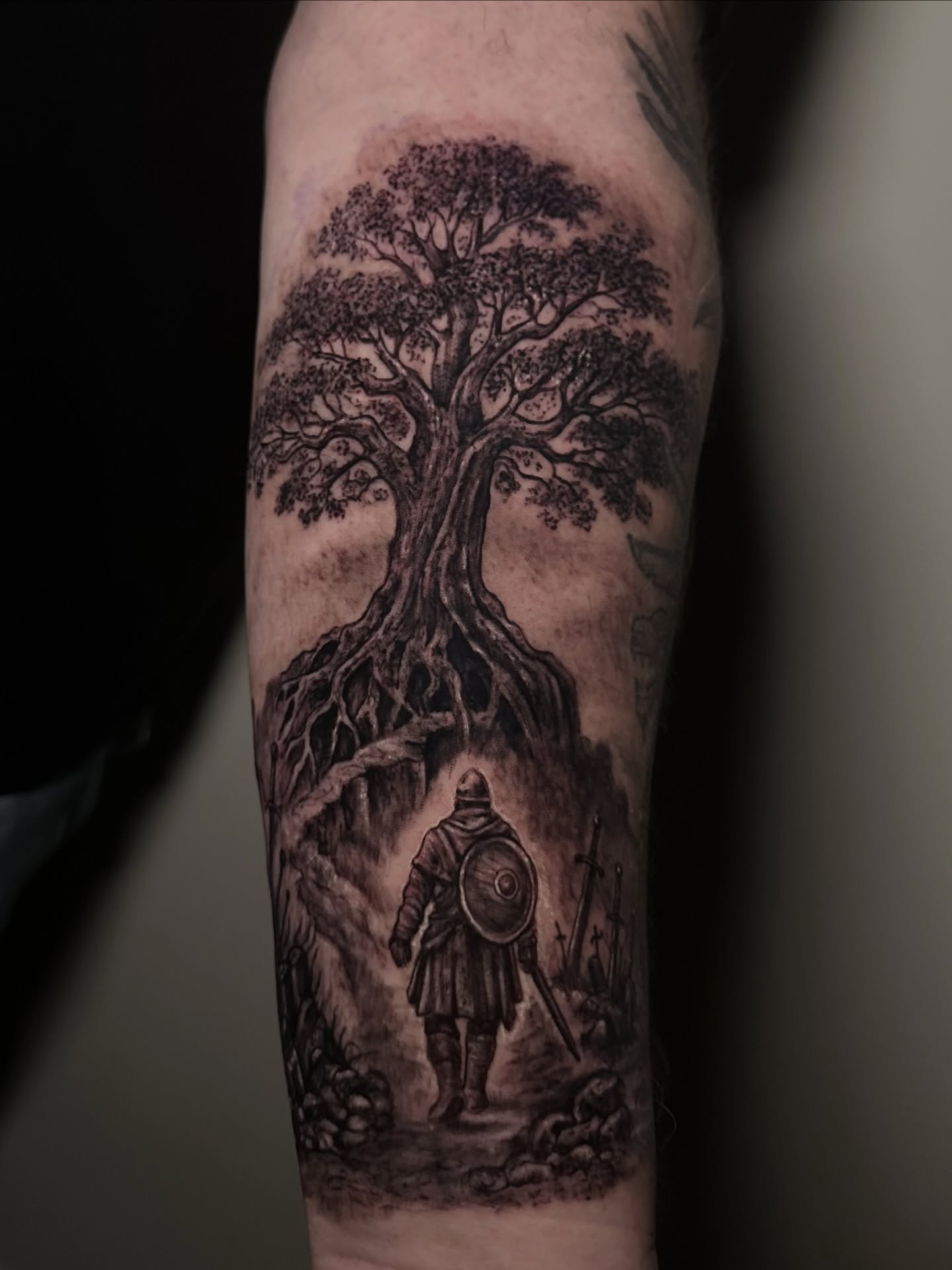 Tree and warrior realism tattoo on the forearm by Héctor Agudelo