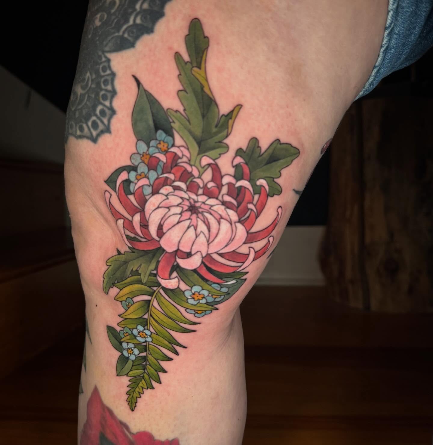 Chrysanthemum American traditional tattoo on the forearm by Katy Bisby