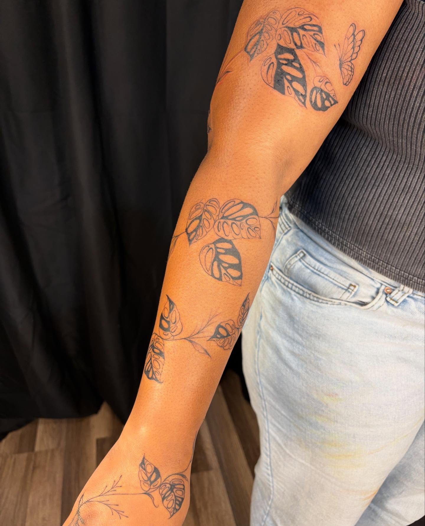 Monstera leaves black and grey tattoo on the forearm by ꩜ 𖦹