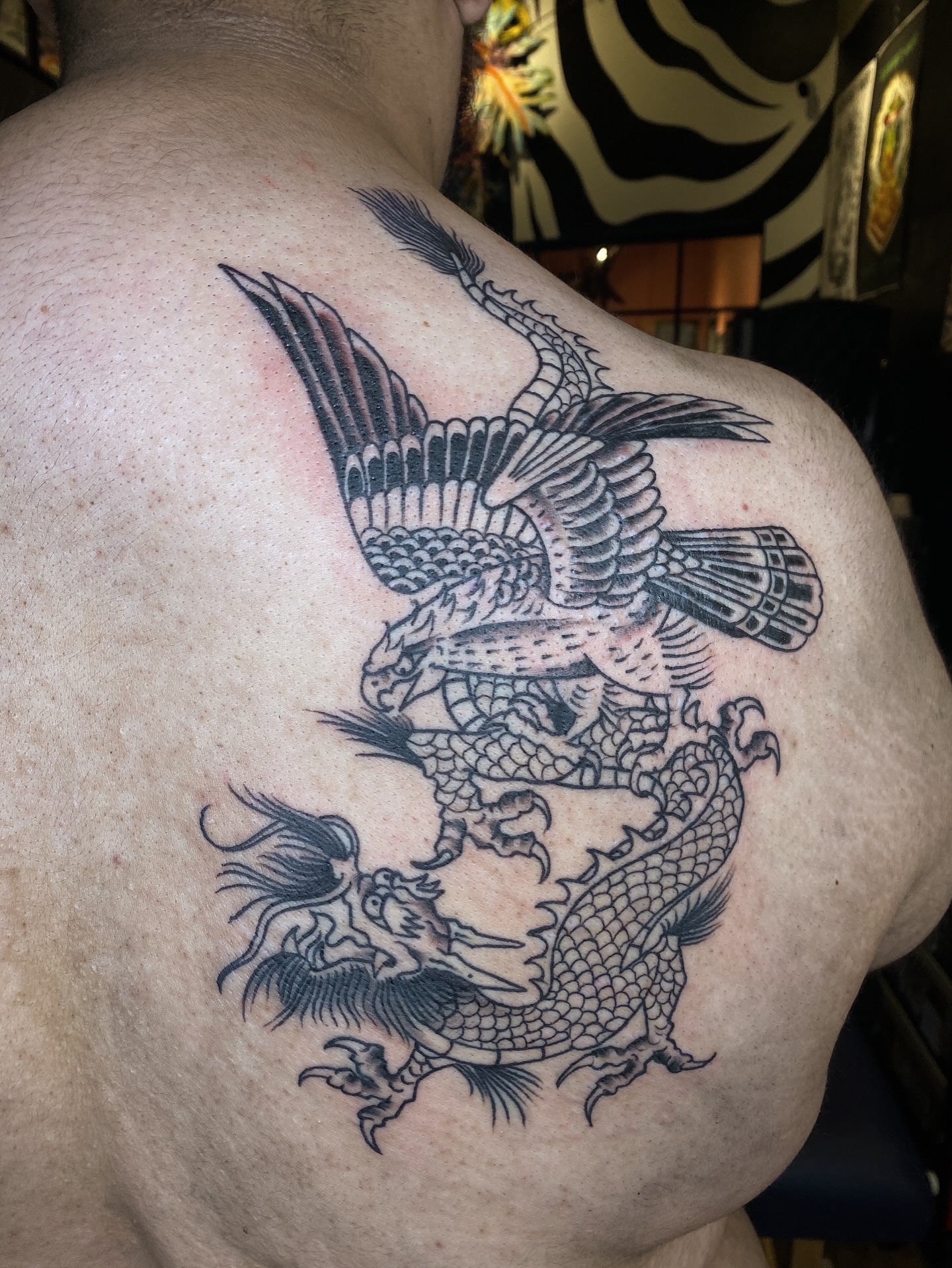 Dragon and phoenix realism tattoo on the back by Karl Hegwein, Portland, Oregon