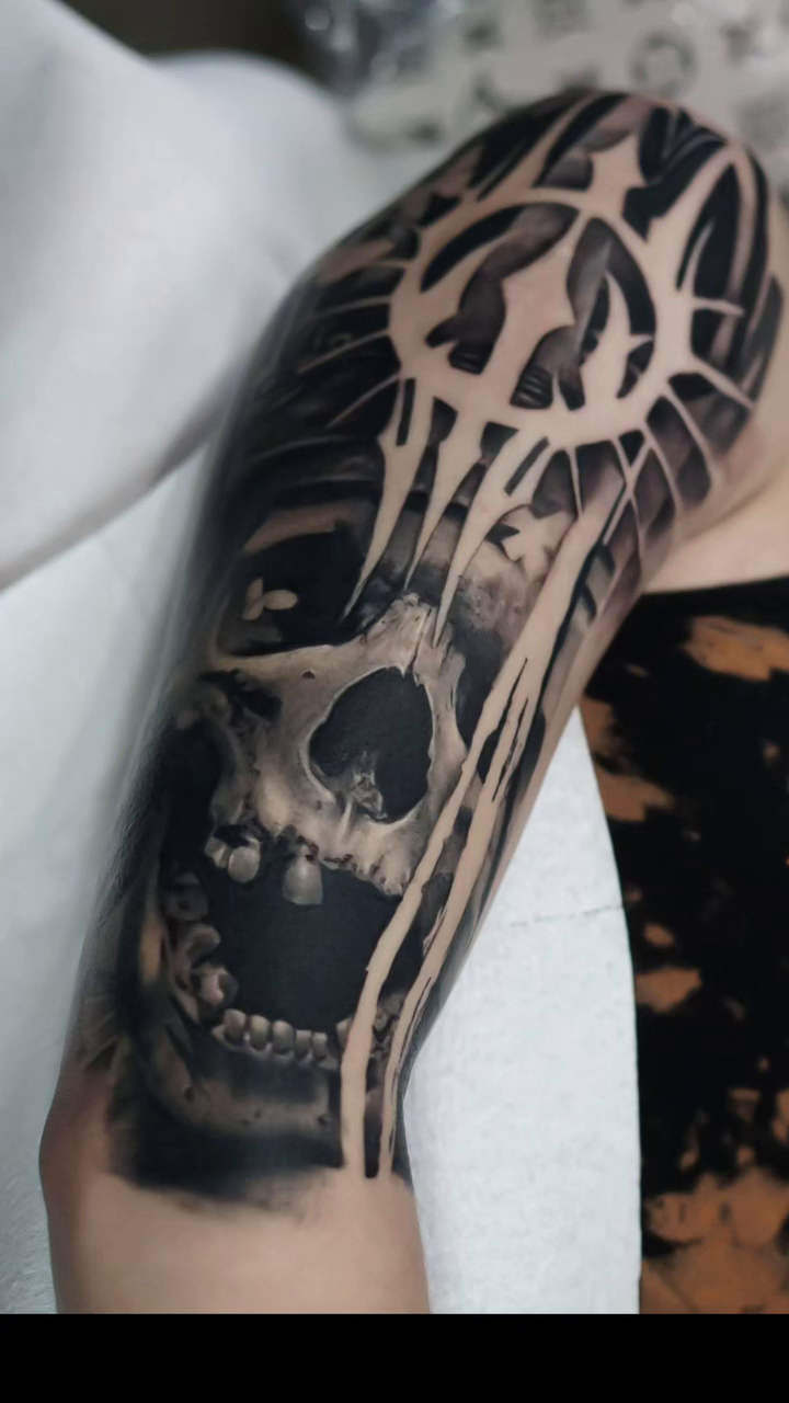 Skull and abstract design realism tattoo by Jimbo