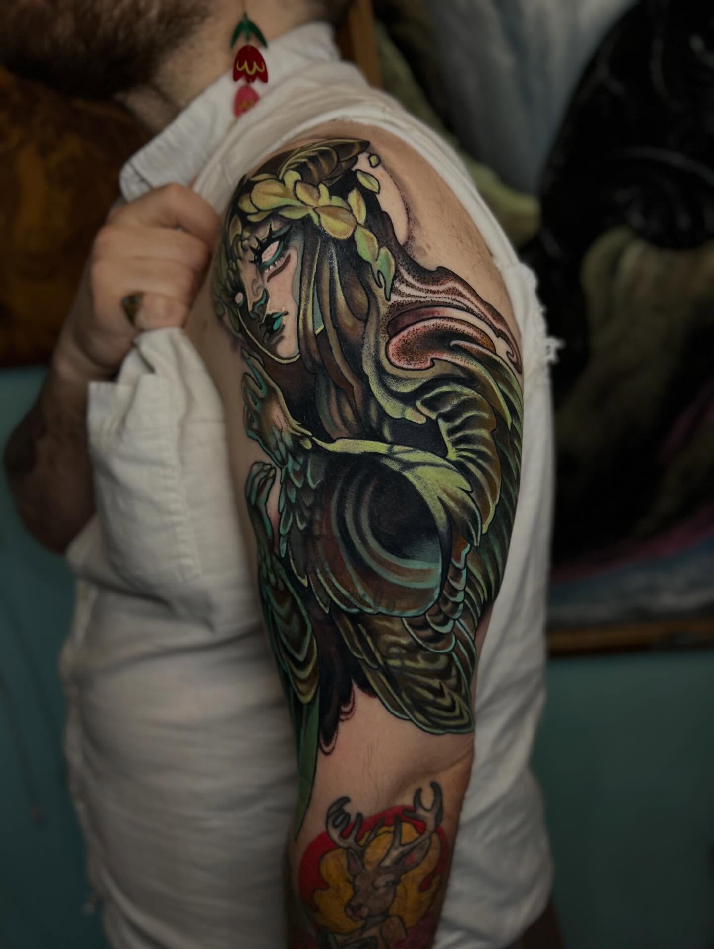 Woman with dragon new school tattoo on the upper arm by Jen Love