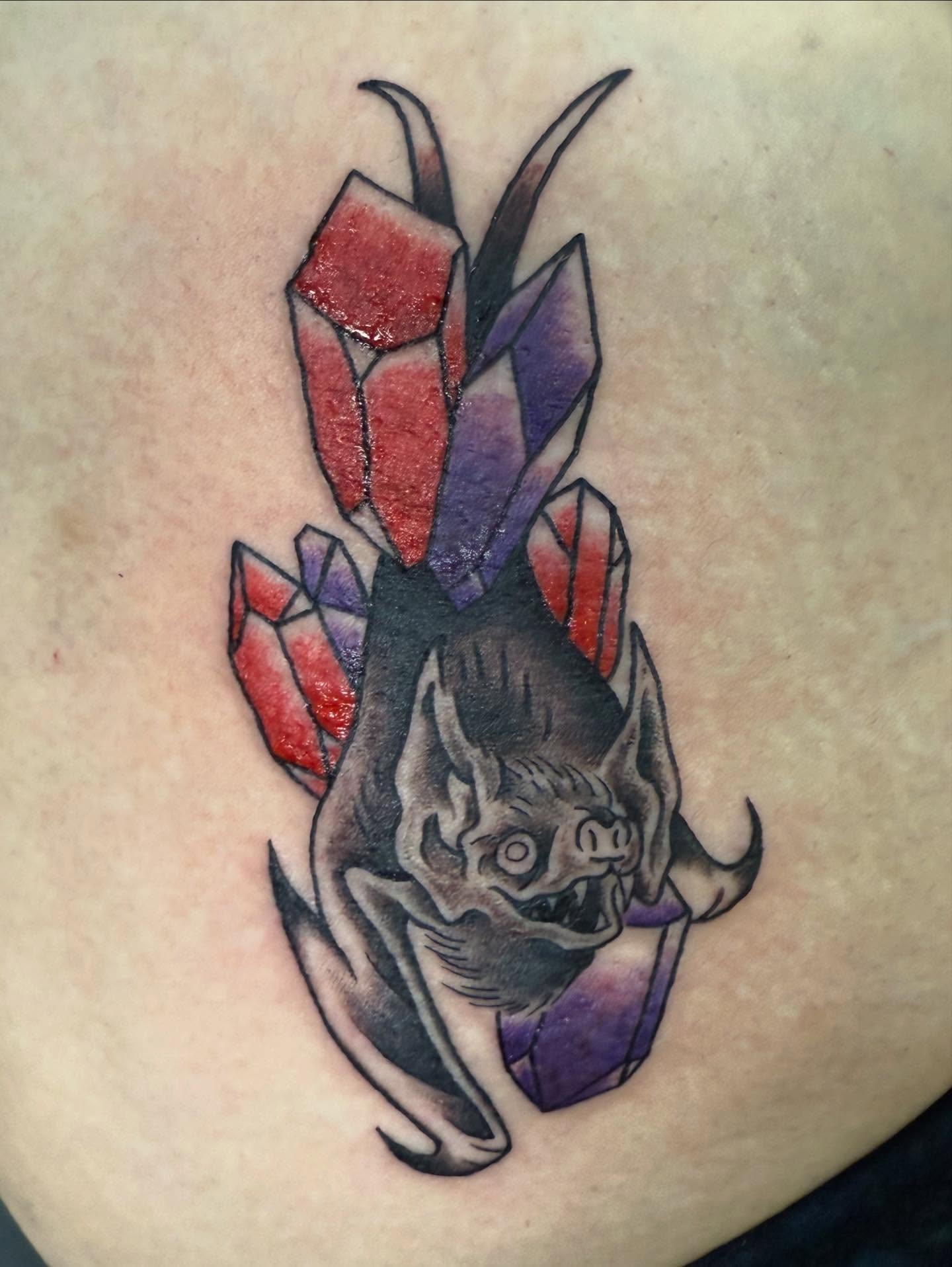 Bat and crystals dark realism tattoo on the thigh by Hunter Beyer