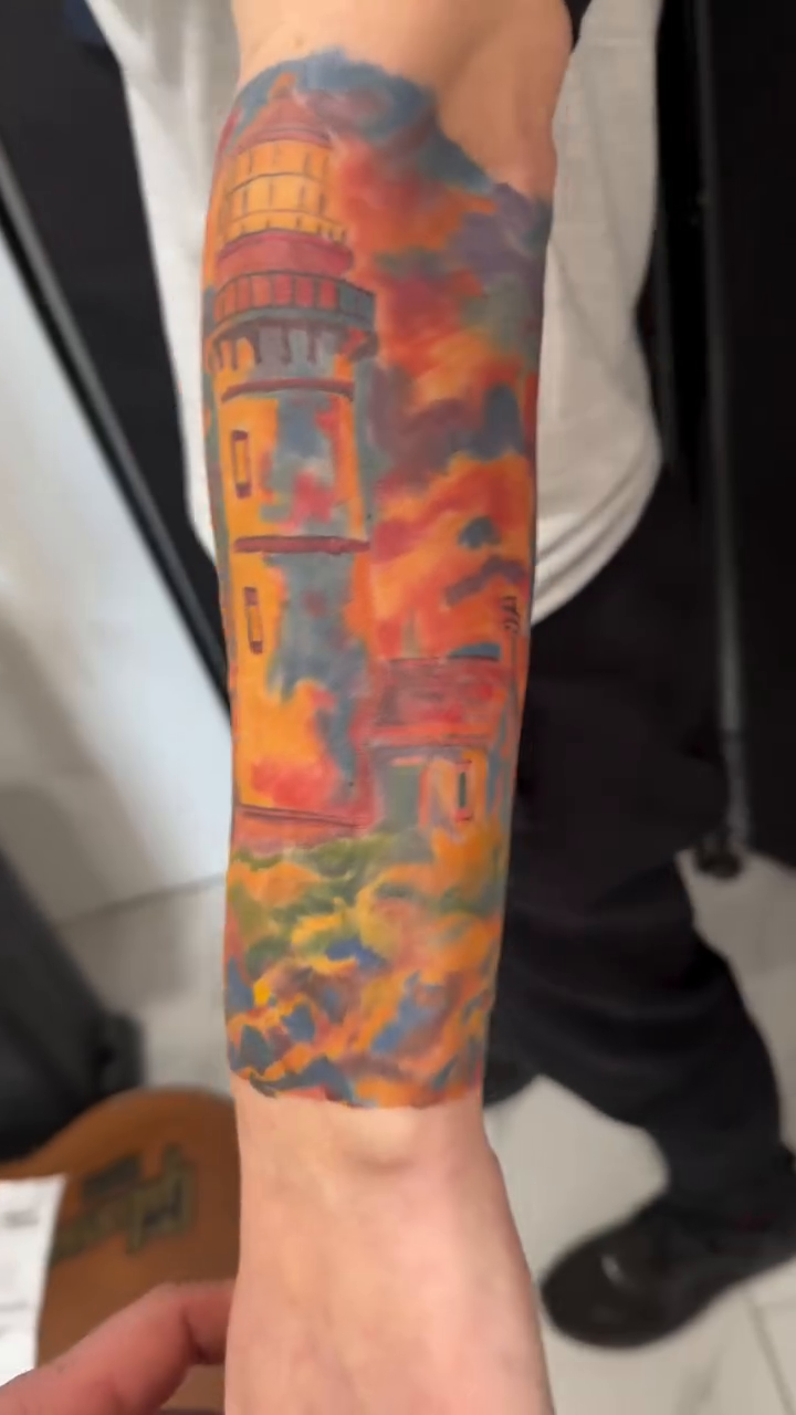 Lighthouse and tropical foliage at sunset realism tattoo by Nicholas Misitano