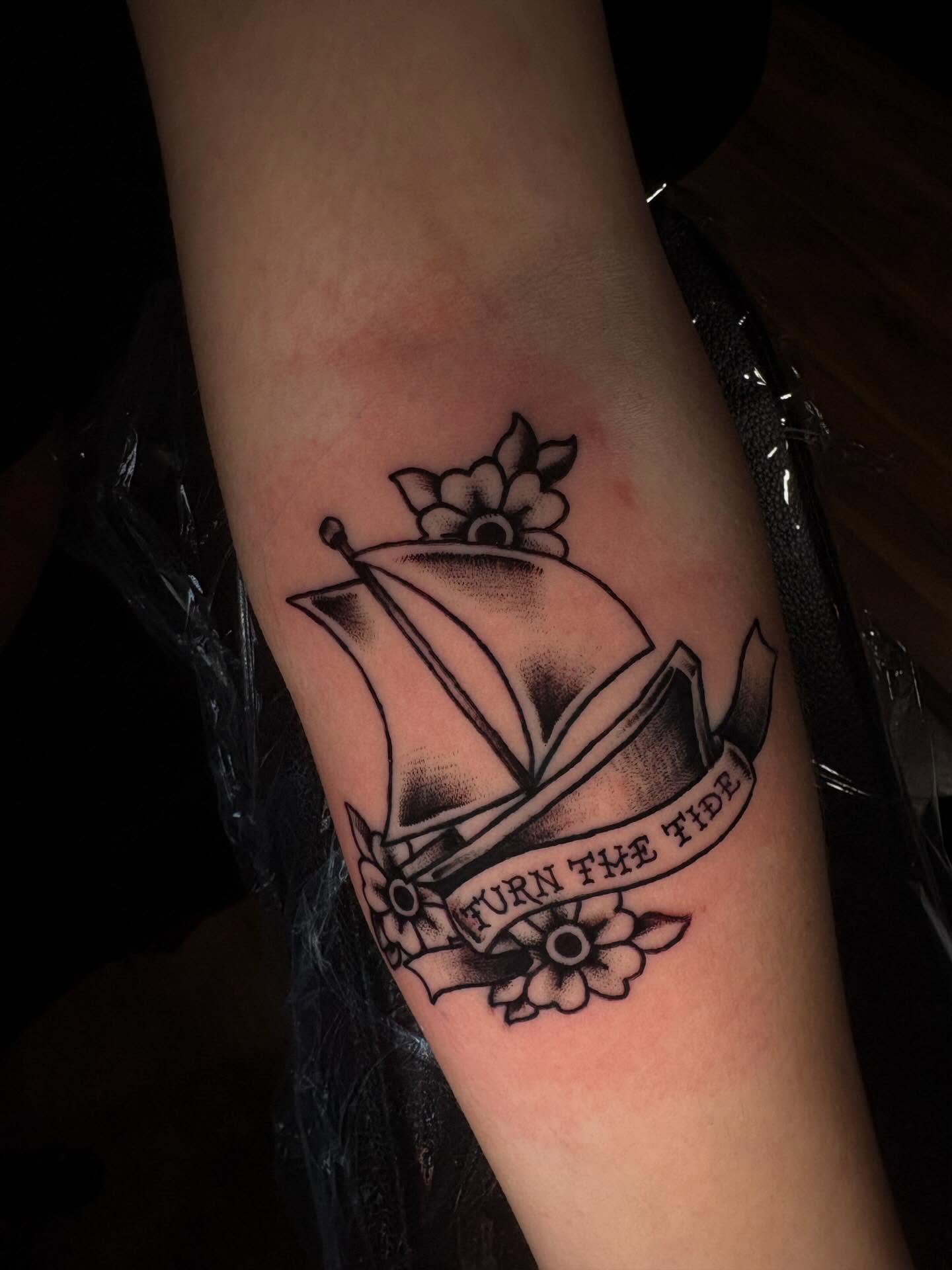 Sailboat with banner American traditional tattoo on the forearm by Jenna Clayton