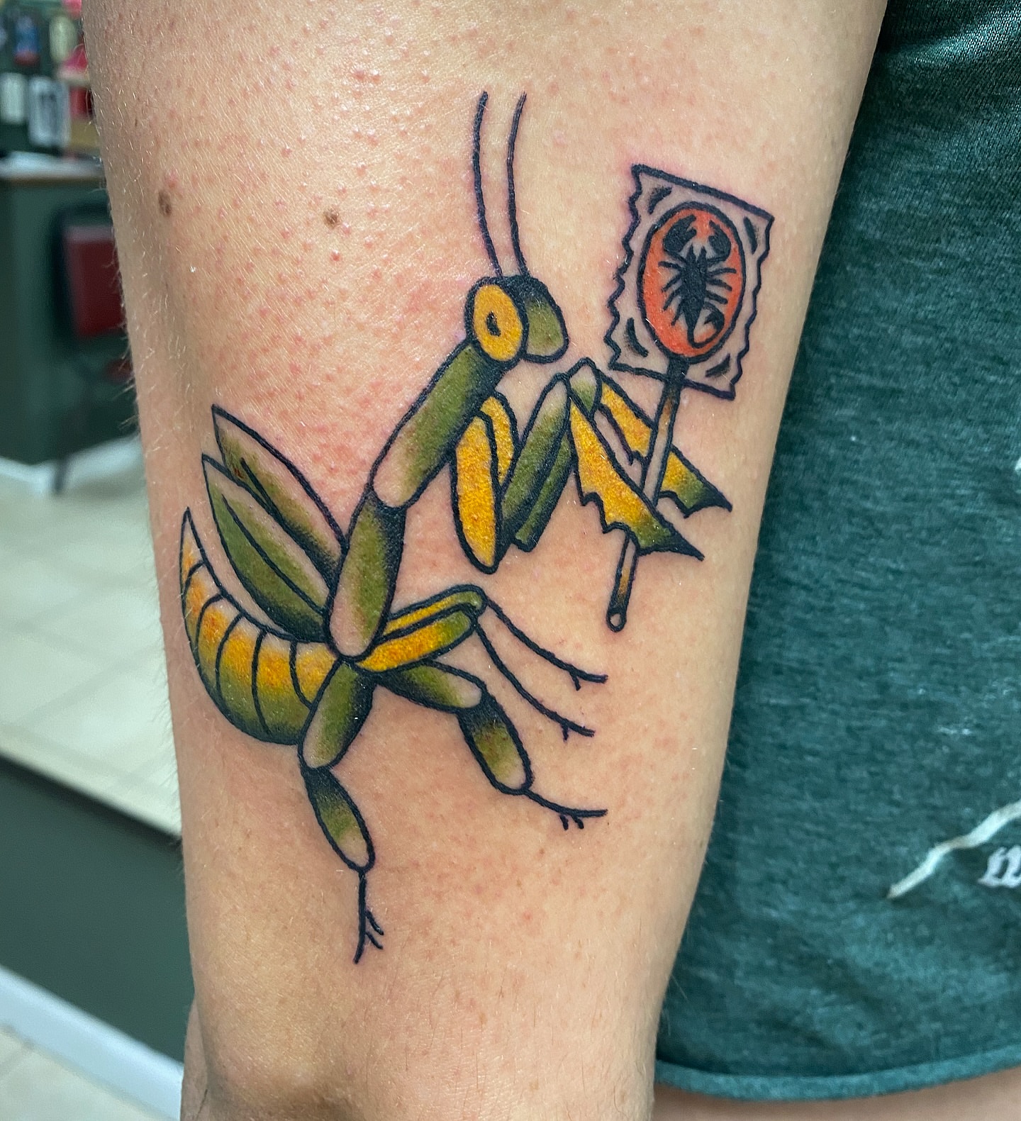 Praying mantis American traditional tattoo on the forearm by Corinne Carter