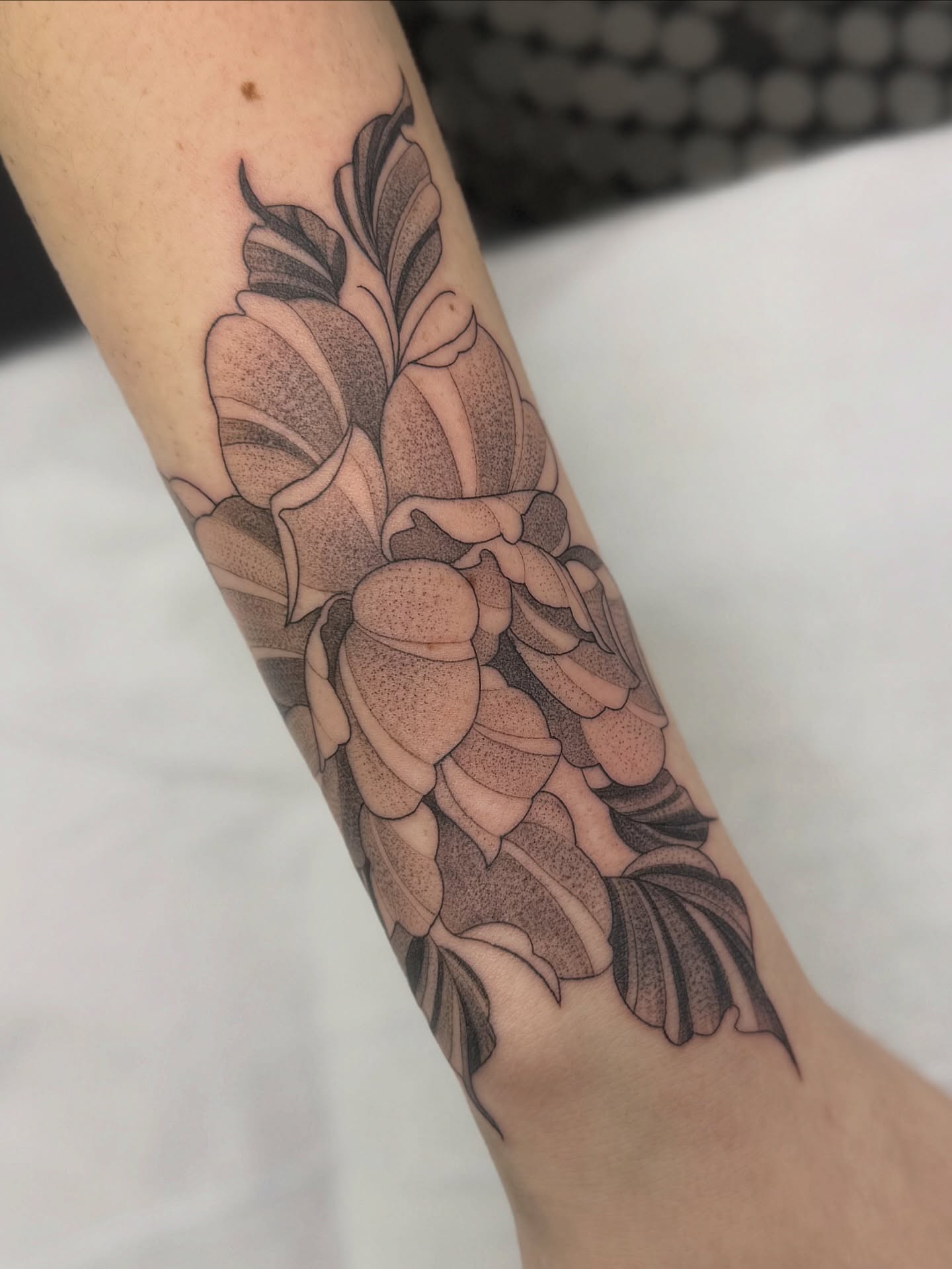 Floral bouquet black and grey tattoo on the forearm by liliana lopez