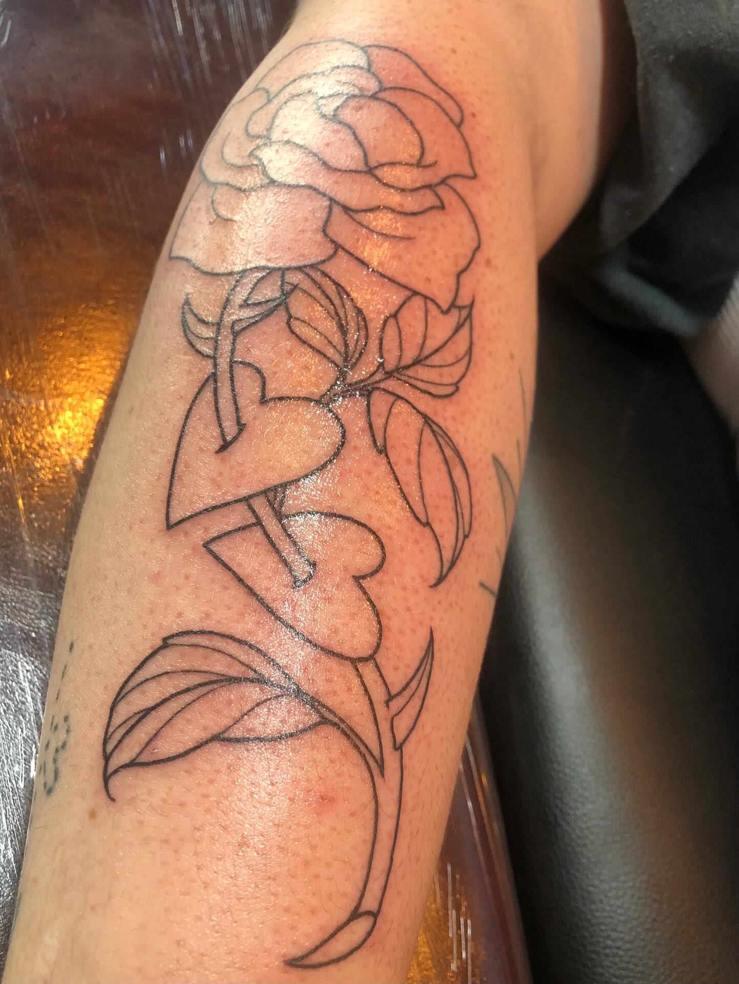 Rose black and grey tattoo on the forearm by Leah Leinani