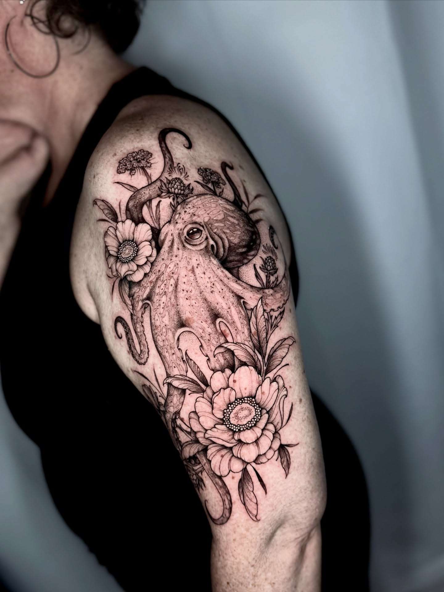 Octopus and flowers realism tattoo on the shoulder by Kathryn Semus