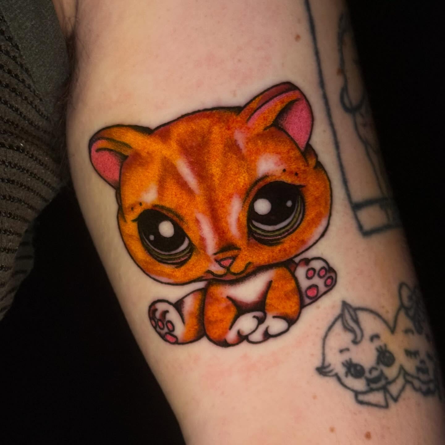 Cat dotwork tattoo on the forearm by Mallory Brown