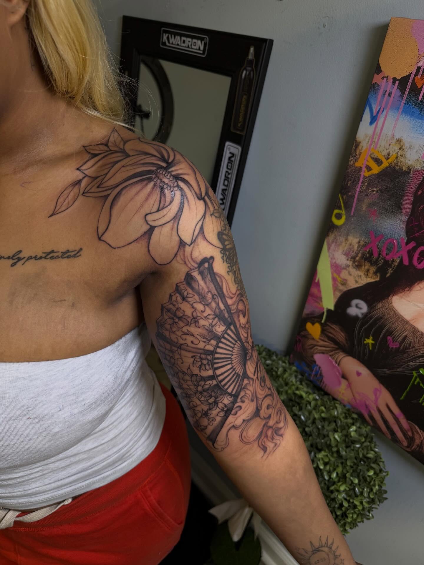 Flower and fan American traditional tattoo on the upper arm by Stephania ATLANTA TATTOO ARTIST🎨