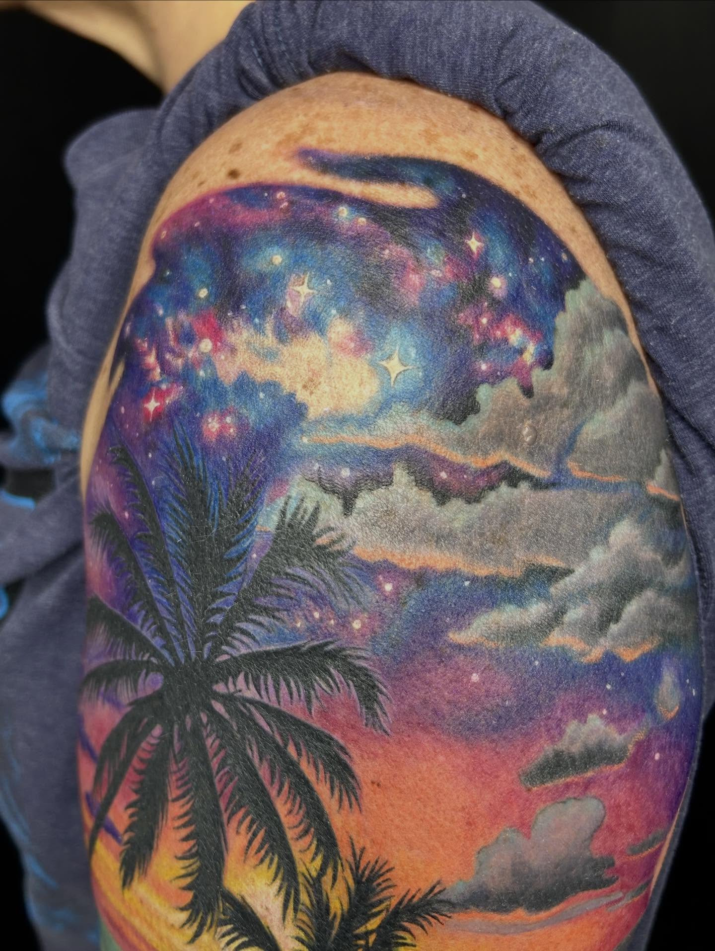 Night sky with palm trees realism tattoo on the shoulder by Mary Rose Heckle