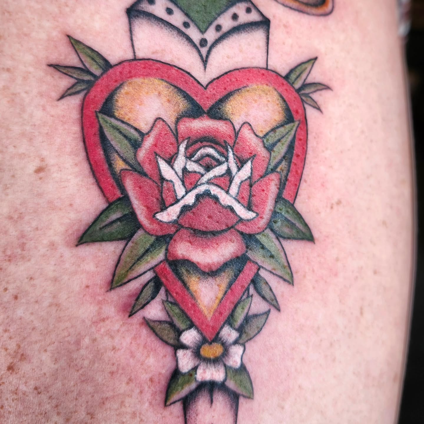 Heart with rose American traditional tattoo on the forearm by Kelly Zito