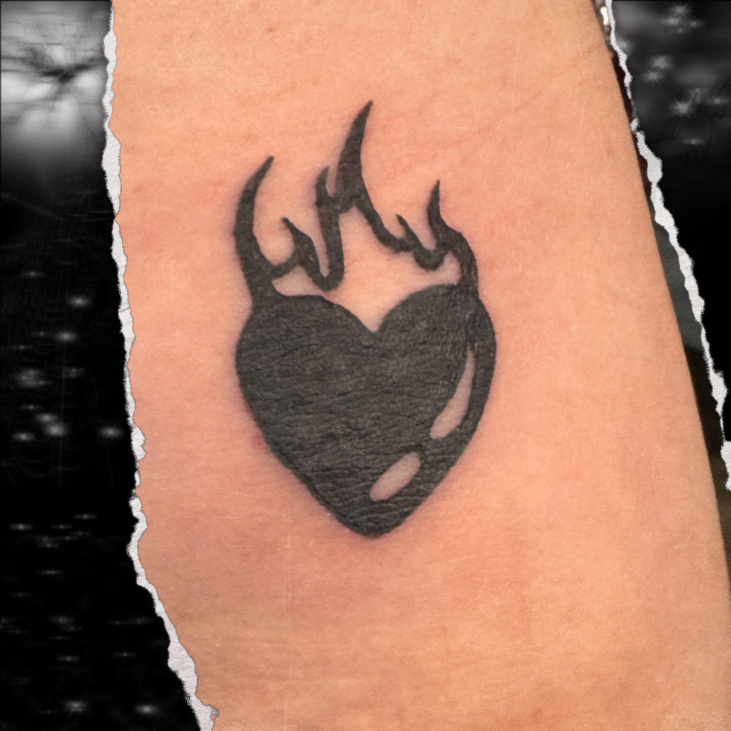 Burning heart black and grey tattoo on the forearm by Seth Christianson