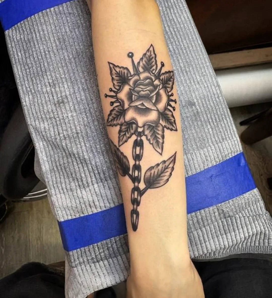 Rose and chain American traditional tattoo on the forearm by Josh Sroga