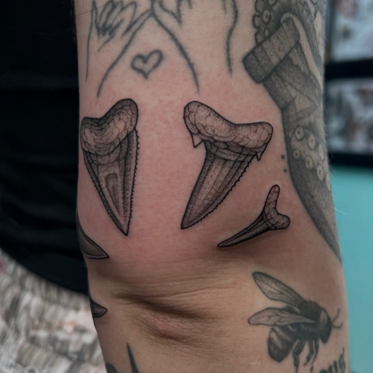 Shark teeth black and grey tattoo on the forearm by Austin Tattoo Artist