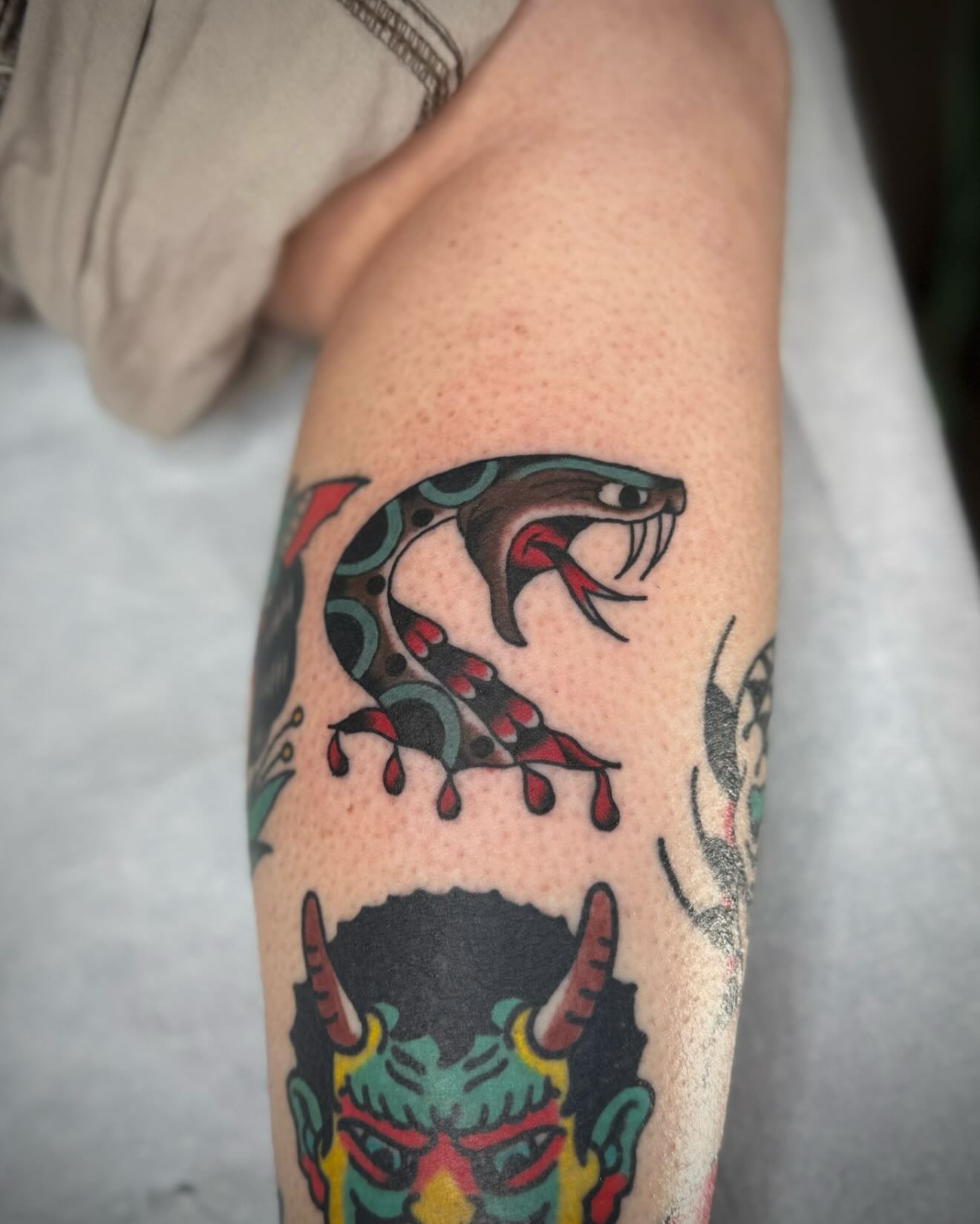 Snake American traditional tattoo on the forearm by kalli berry