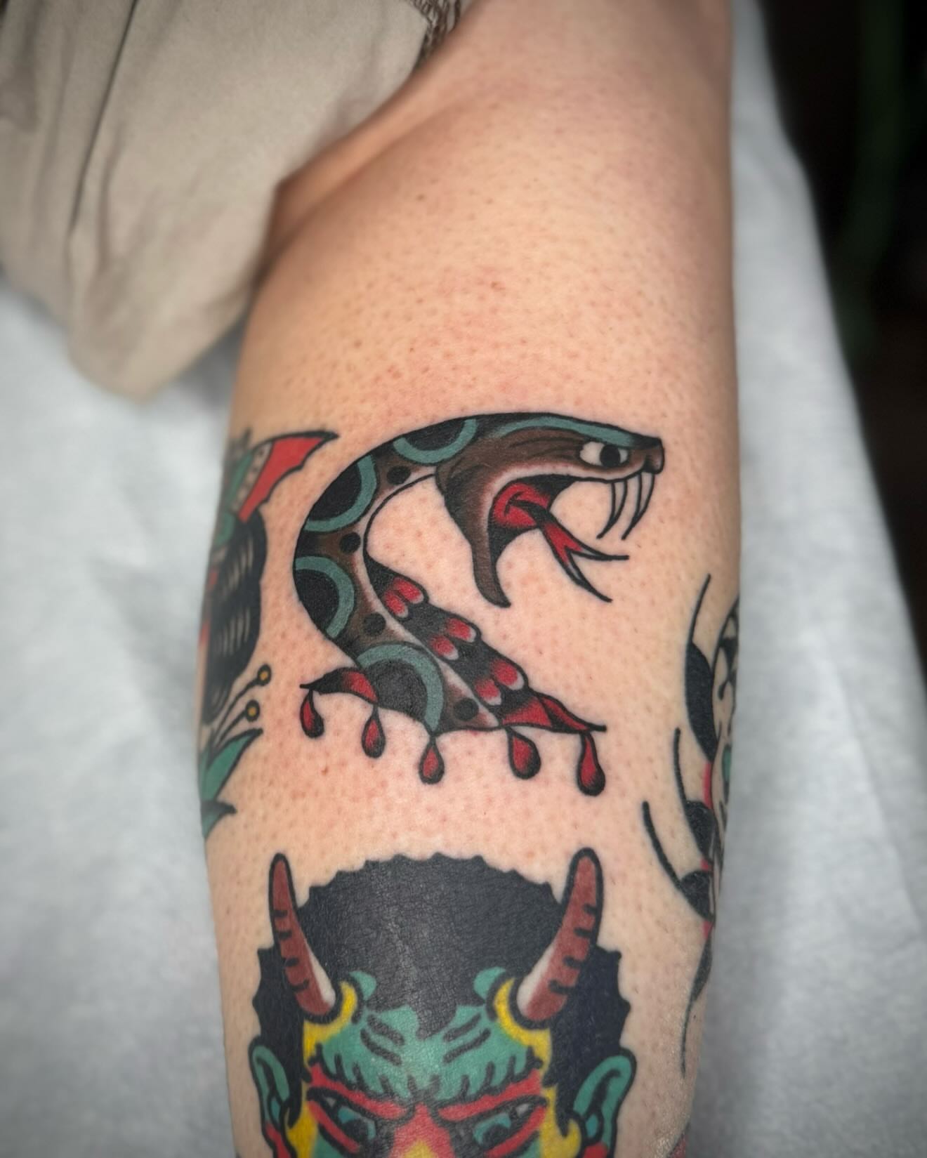Snake American traditional tattoo on the forearm by kalli berry