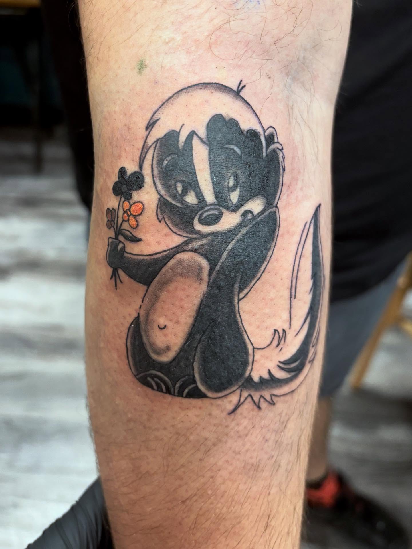 Badger holding flower black and grey tattoo on the forearm by ✨Tattoos By Martina ✨