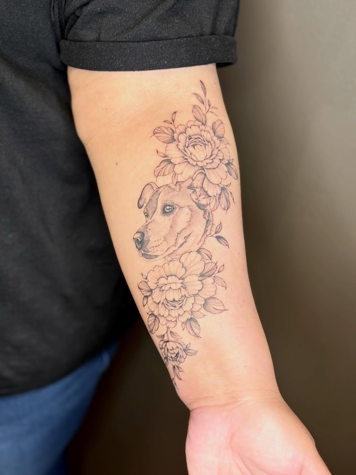 Dog with floral arrangement realism tattoo on the forearm by 🖤Sidney🖤