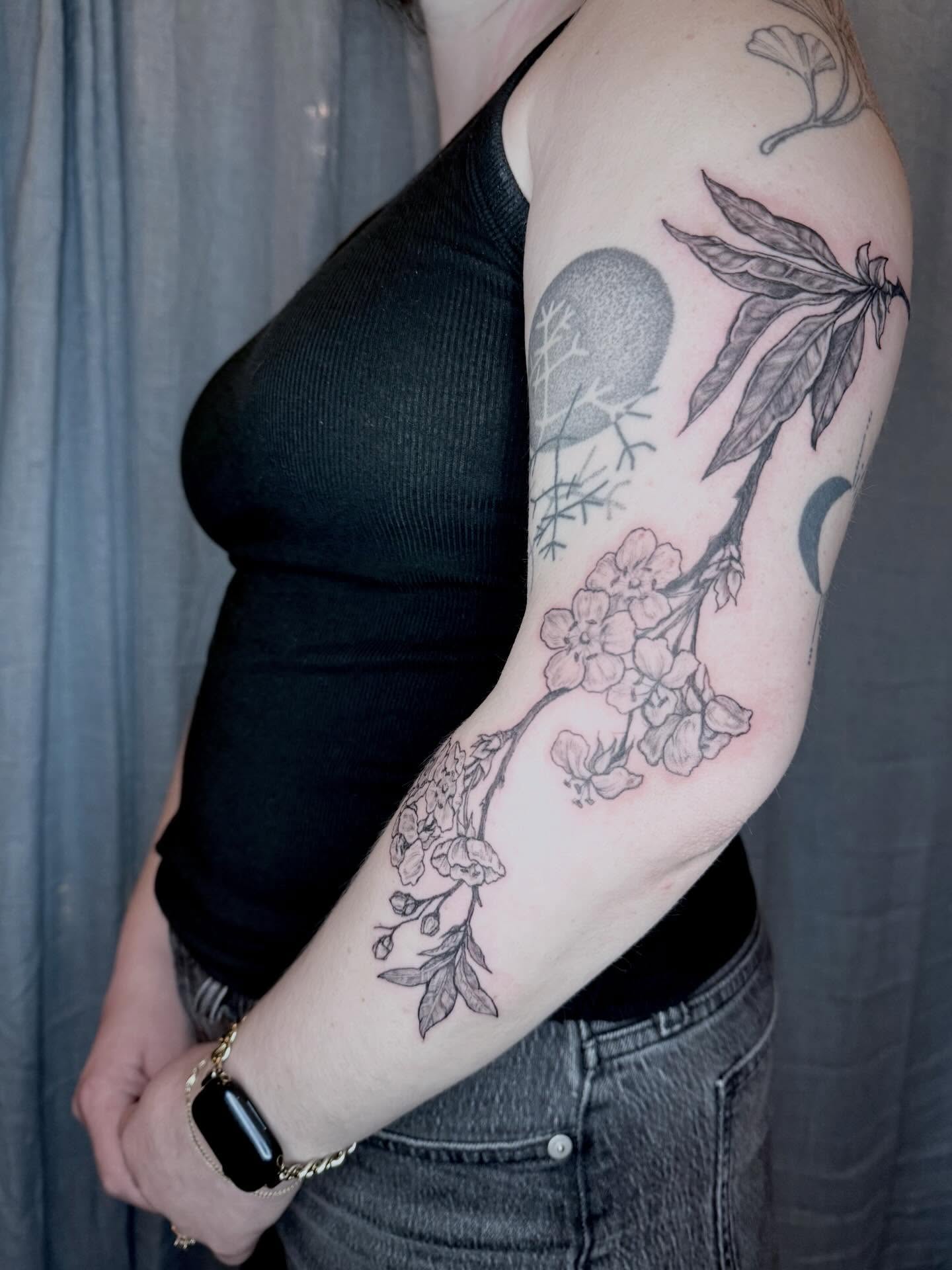 Moon and floral branches realism tattoo on the forearm by Emily Rose Lumsdaine