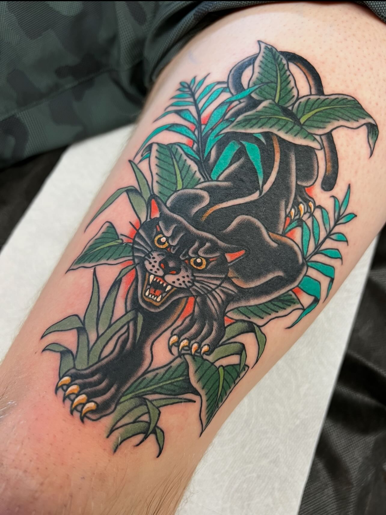 Panther American traditional tattoo on the thigh by Kelsey Lane