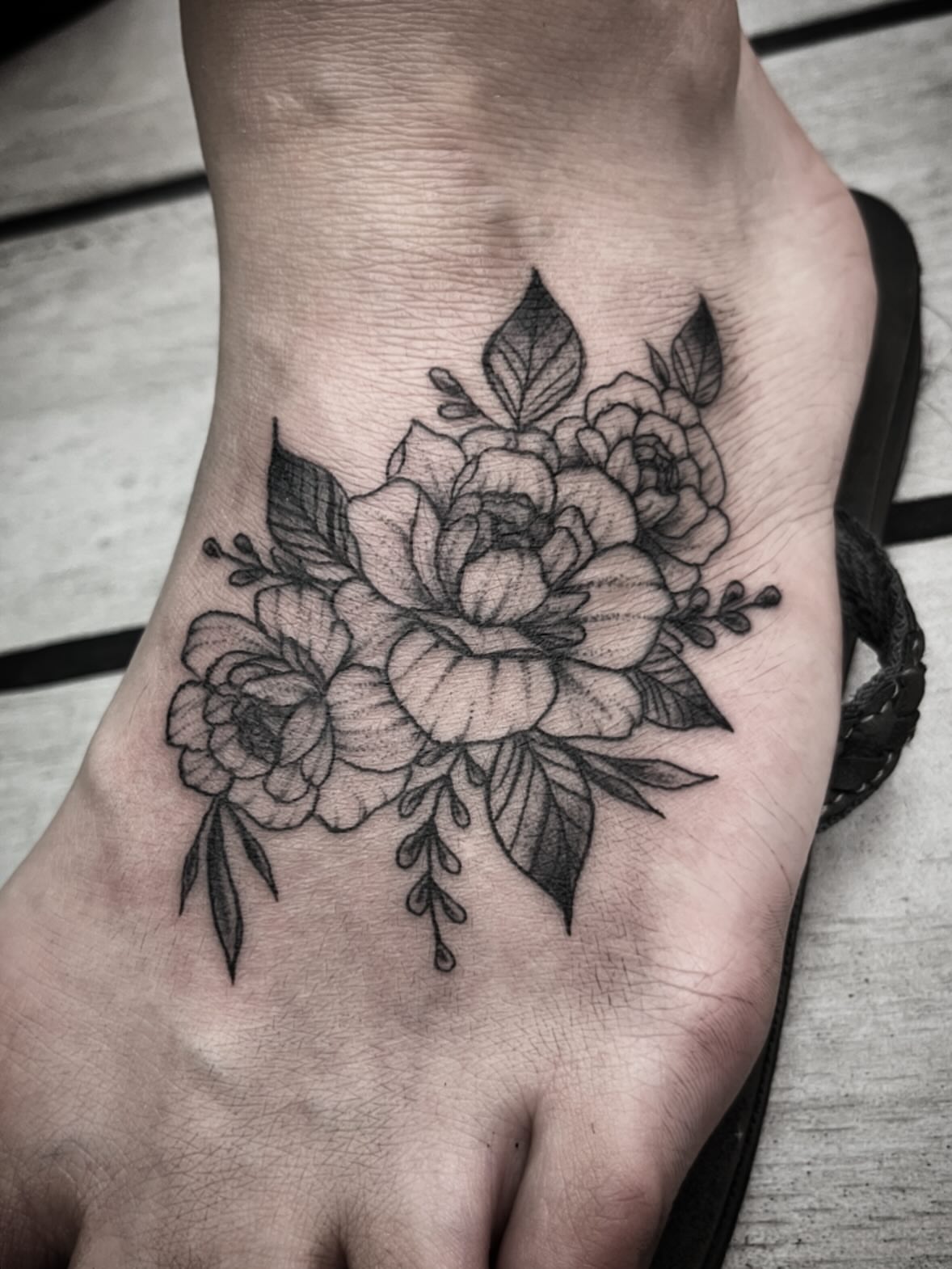 Floral bouquet black and grey tattoo on the foot by Sean Gallagher