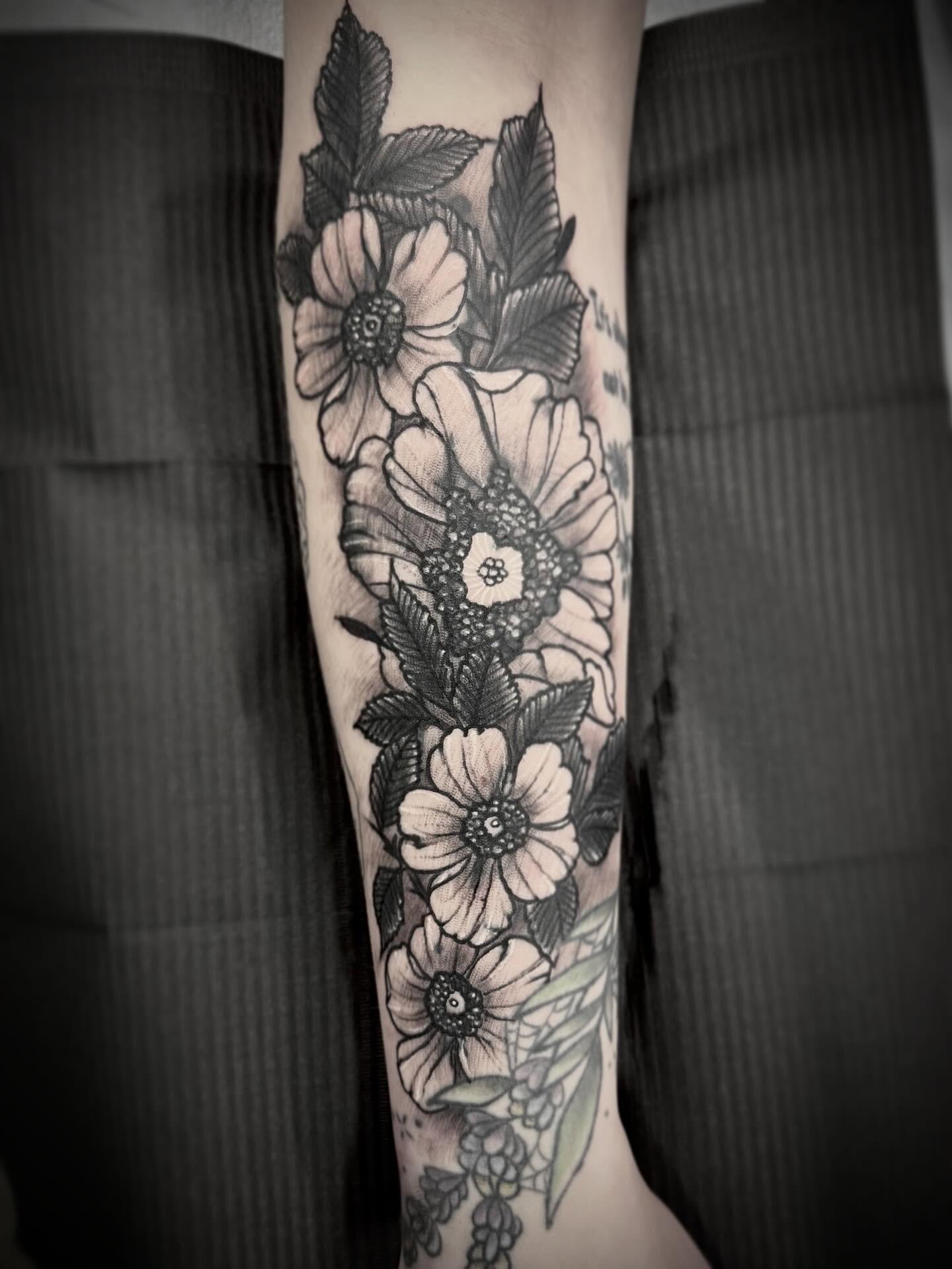 Floral bouquet black and grey tattoo on the forearm by Alec Bauer