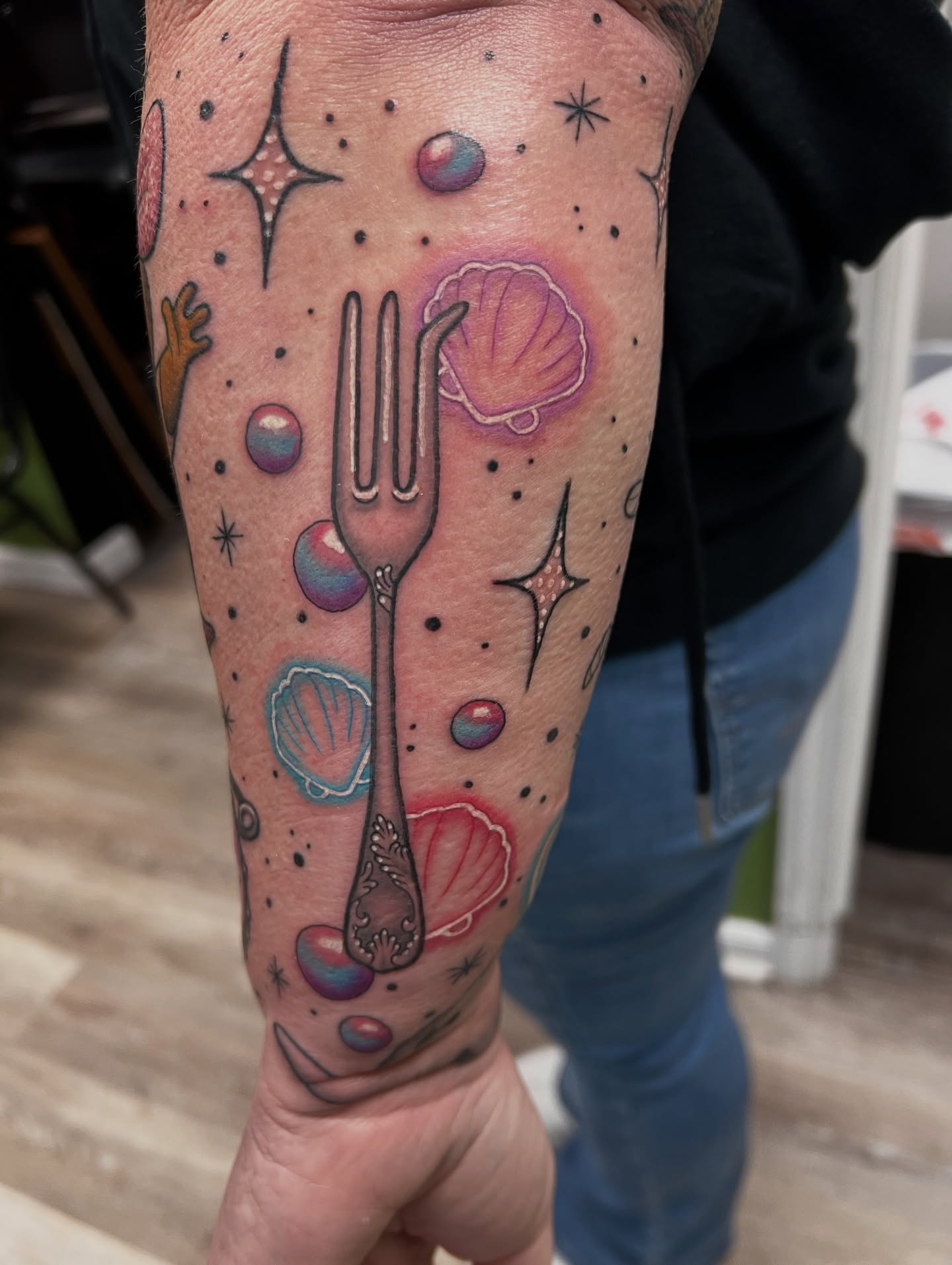 Fork and shells dotwork tattoo on the forearm by Olivia Suzanne Fada