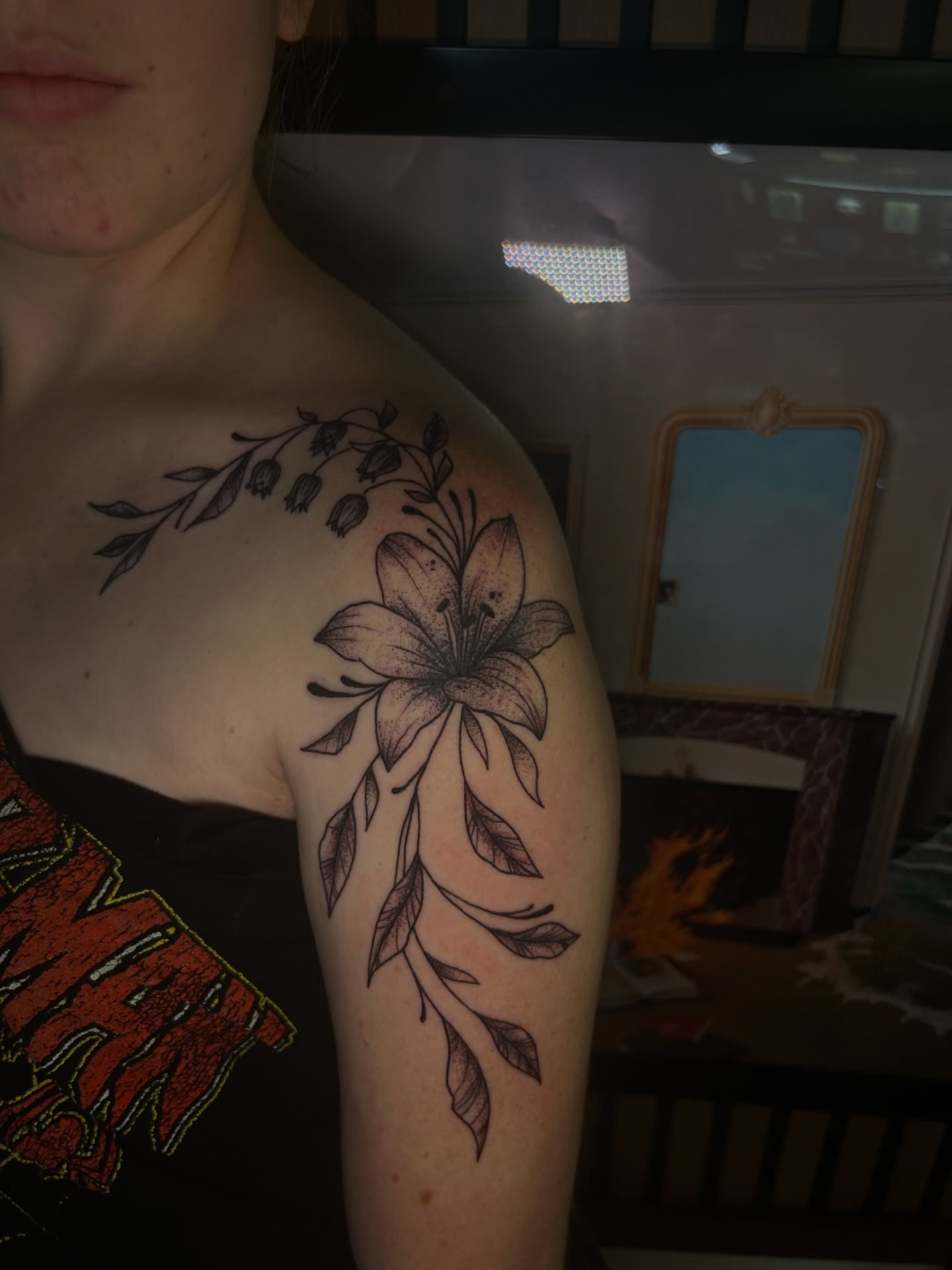 Lily and leaves black and grey tattoo on the shoulder by Torrey, Austin, Texas