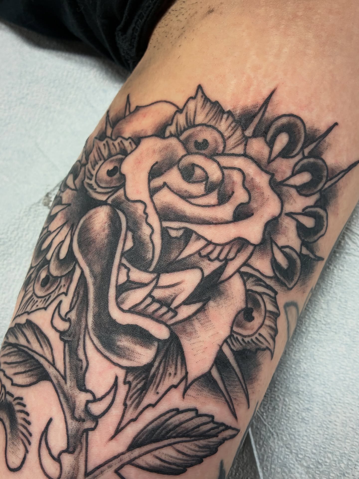 Rose black and grey tattoo on the forearm by Kennedy Cole