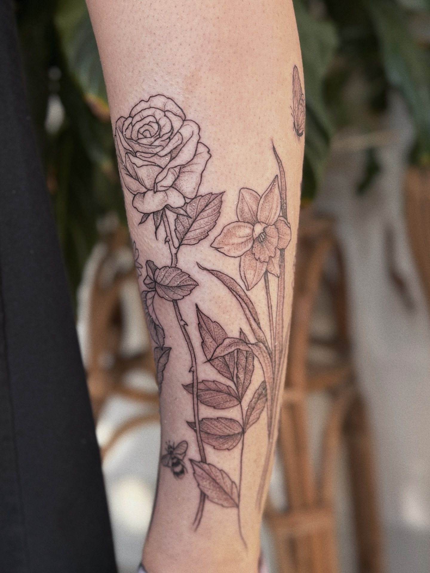 Floral arrangement black and grey tattoo on the forearm by 𝕵𝖊𝖘𝖘𝖎𝖈𝖆 𝕰𝖑 (raleigh tattoo artist)