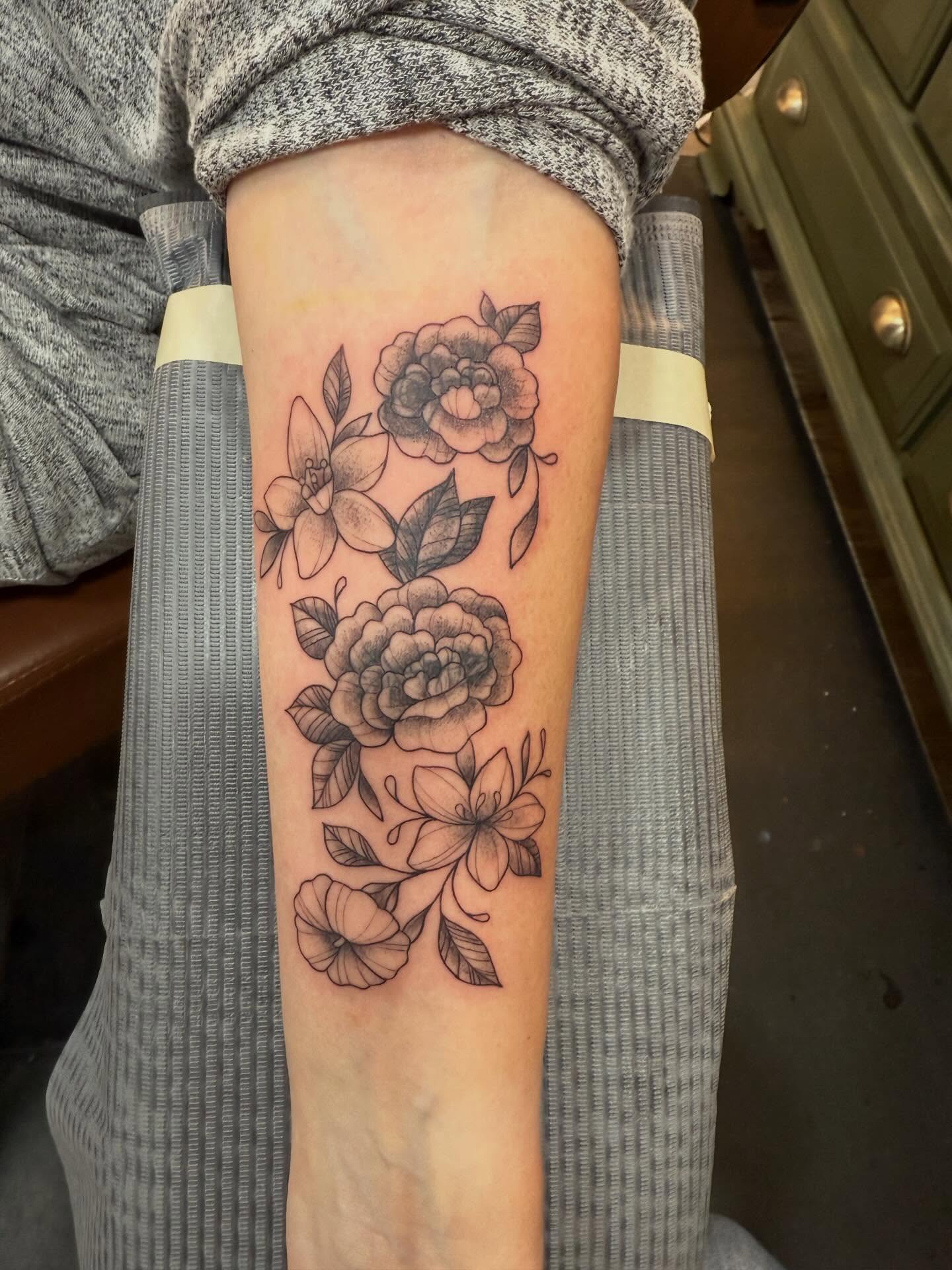 Floral arrangement black and grey tattoo on the forearm by Brandie Caroline, Somers Point, New Jersey
