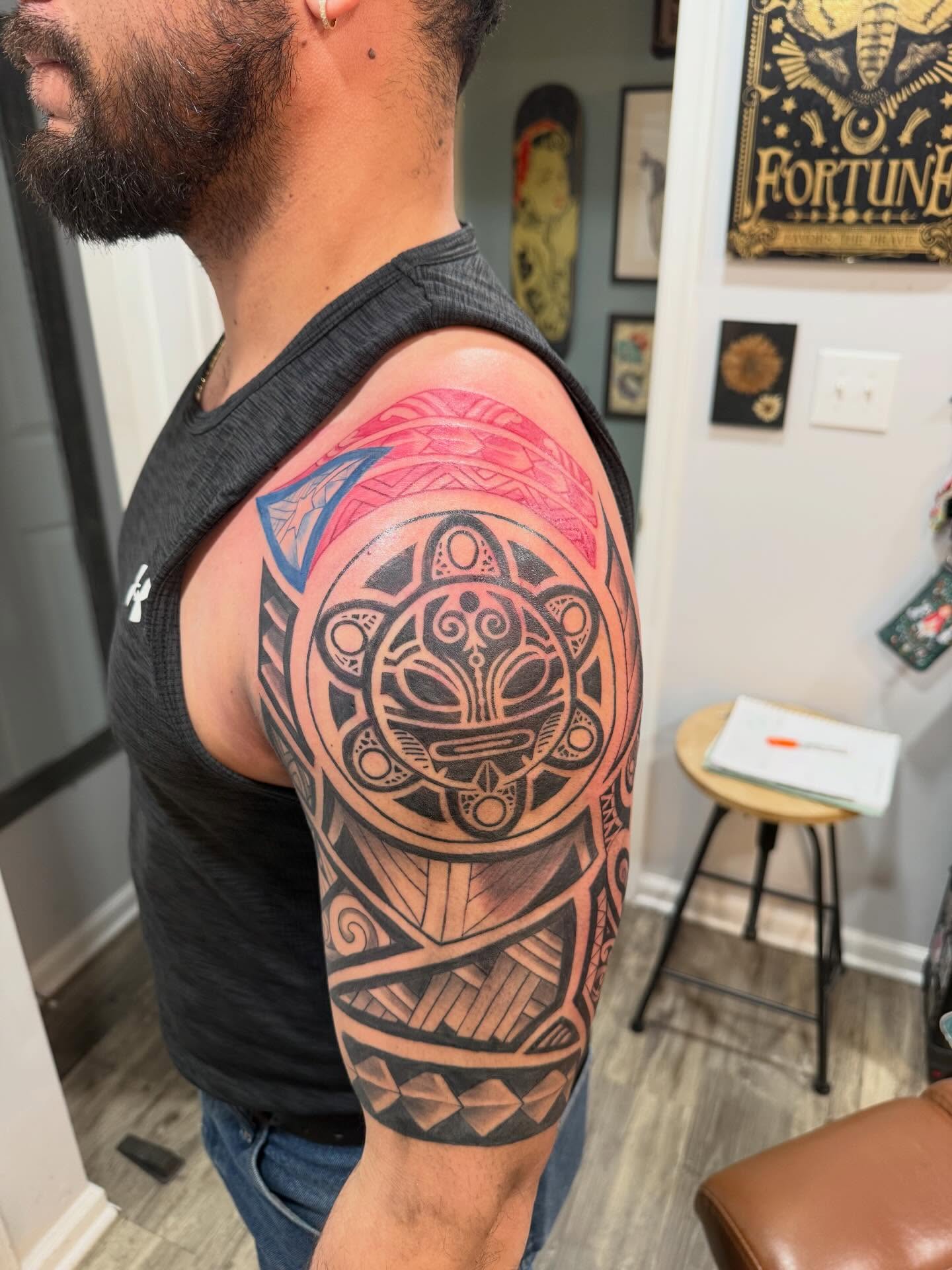 Tribal mask tribal tattoo on the upper arm by Brandie Caroline, Somers Point, New Jersey